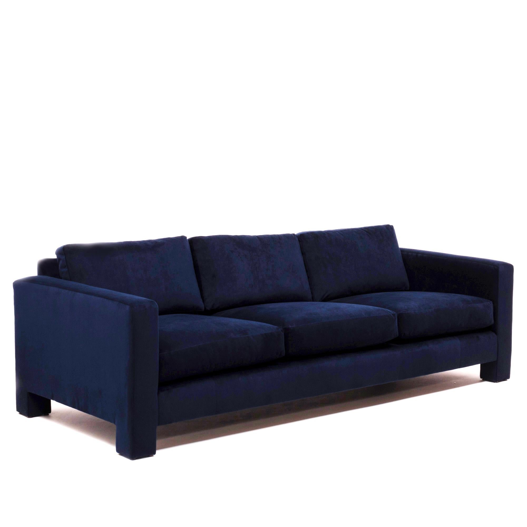 A Classic example of Mid-Century Modern design, this three-seat sofa by Milo Baughman is a timeless piece.

Newly reupholstered in sumptuous navy blue velvet, the sofa has a thick, angular frame and deep, comfortable seating.

The three-seat