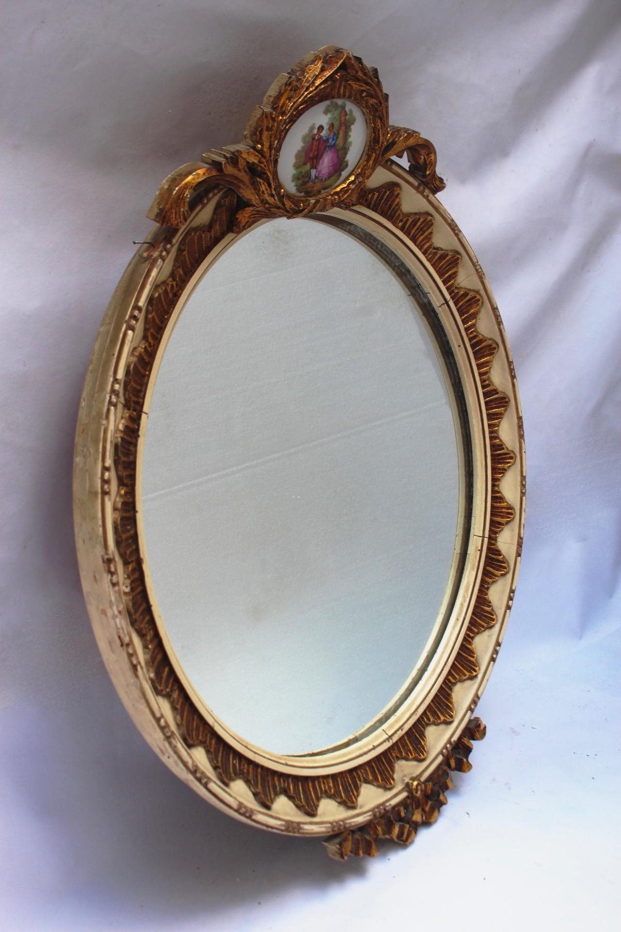 Midcentury neoclassical revival round wood and ceramic wall mirror, made in Spain during the 1950s.
There is a small piece of marquetry missing(Pictured).
The piece remains in distressed condition.