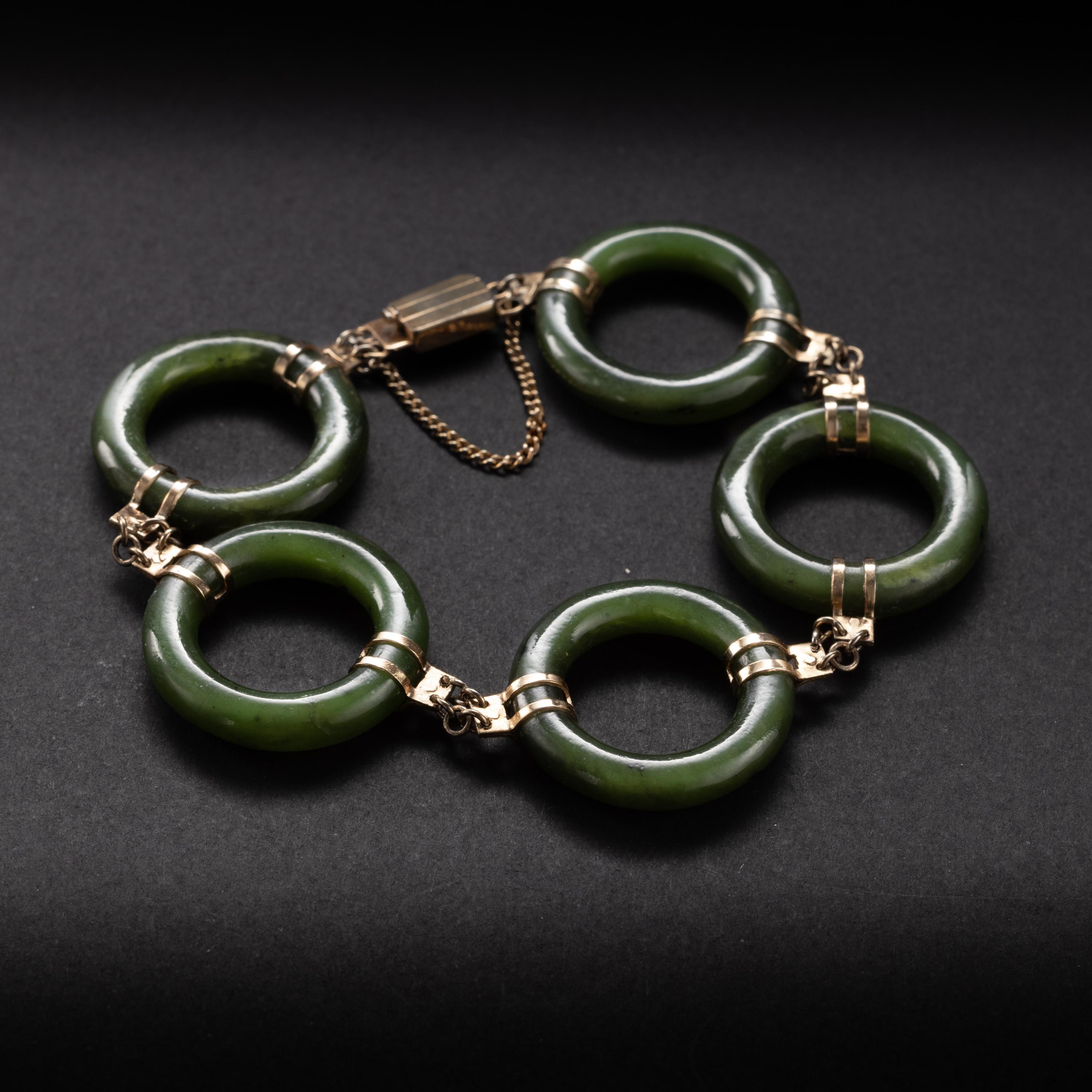Mod, modern, and magnificent! This gorgeous midcentury (circa 1970s-1970s) bracelet is composed of 5 hand-carved Chinese nephrite hoops. This is highly translucent nephrite; what locals call 
