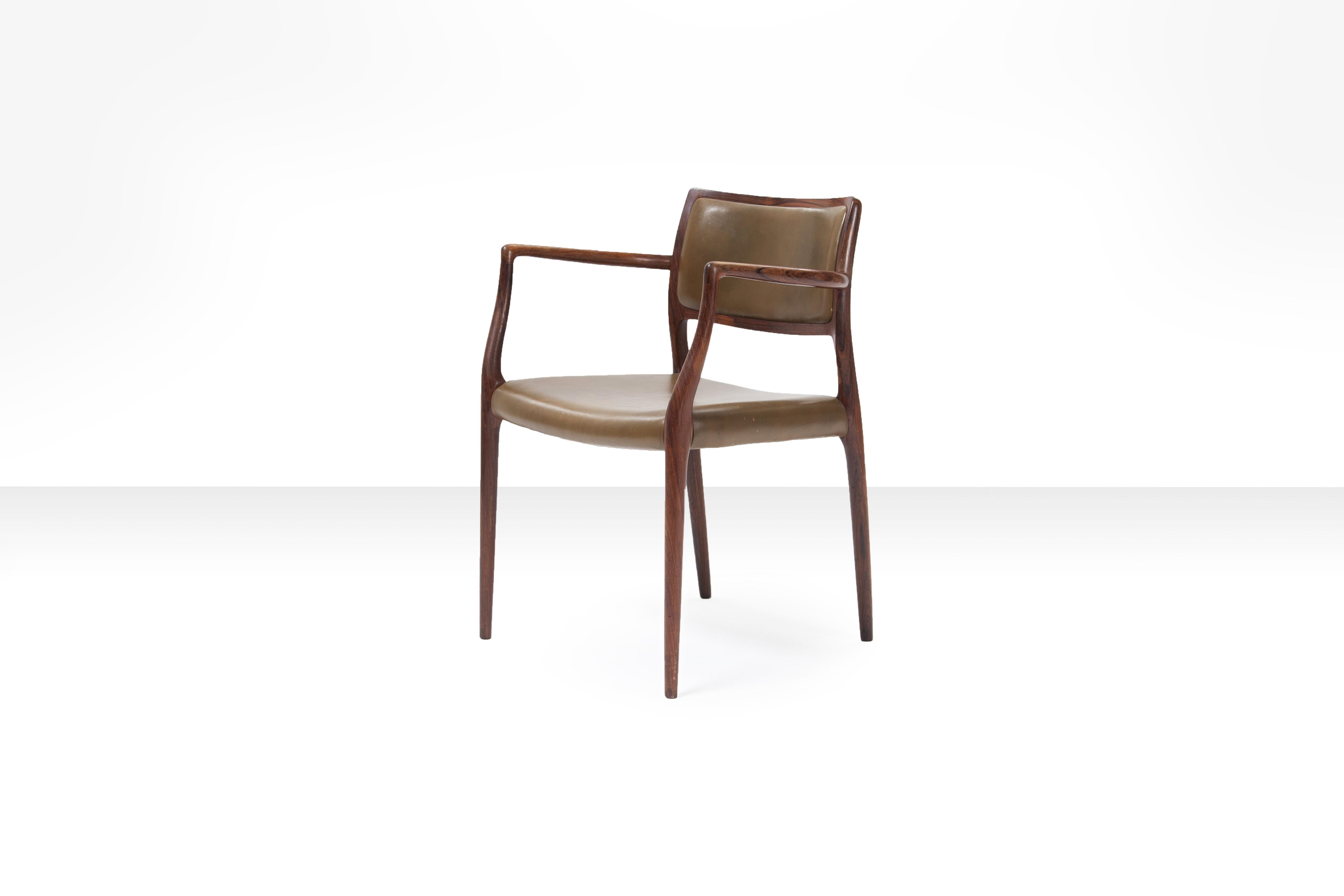 Rosewood Niels O. Møller 'Model 65' armchair with olive green leather seat and back, Denmark, 1960s.

This armchair by Niels Otto Møller will be packaged and shipped with the greatest care and attention to make sure you will receive the work in