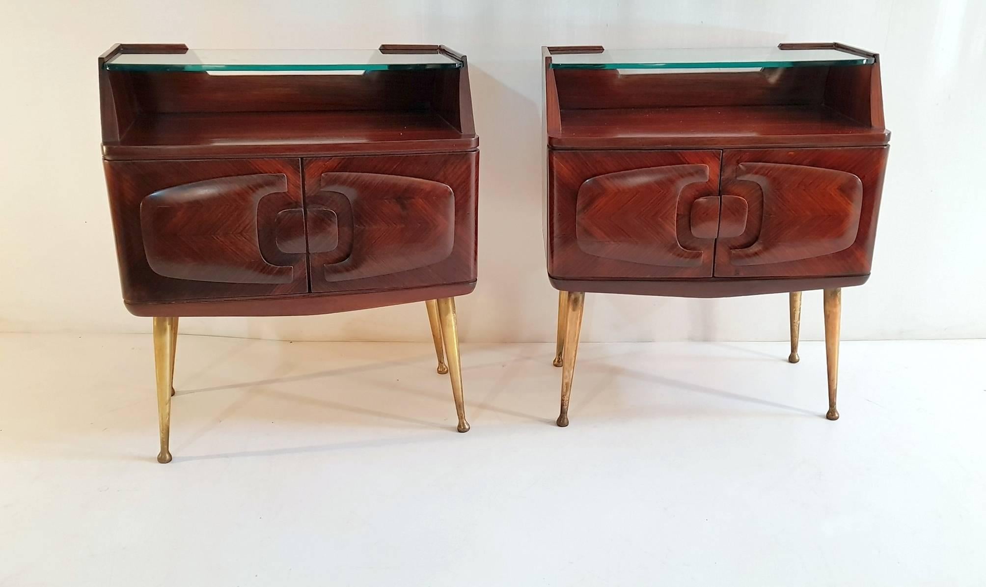 A pair of nightstands by Vittorio Dassi for his own company Dassi Lissone in jacaranda and with spider brass legs. Each nightstand has a pair of doors with an intricate design and glass shelf and details in brass. In excellent restored condition.