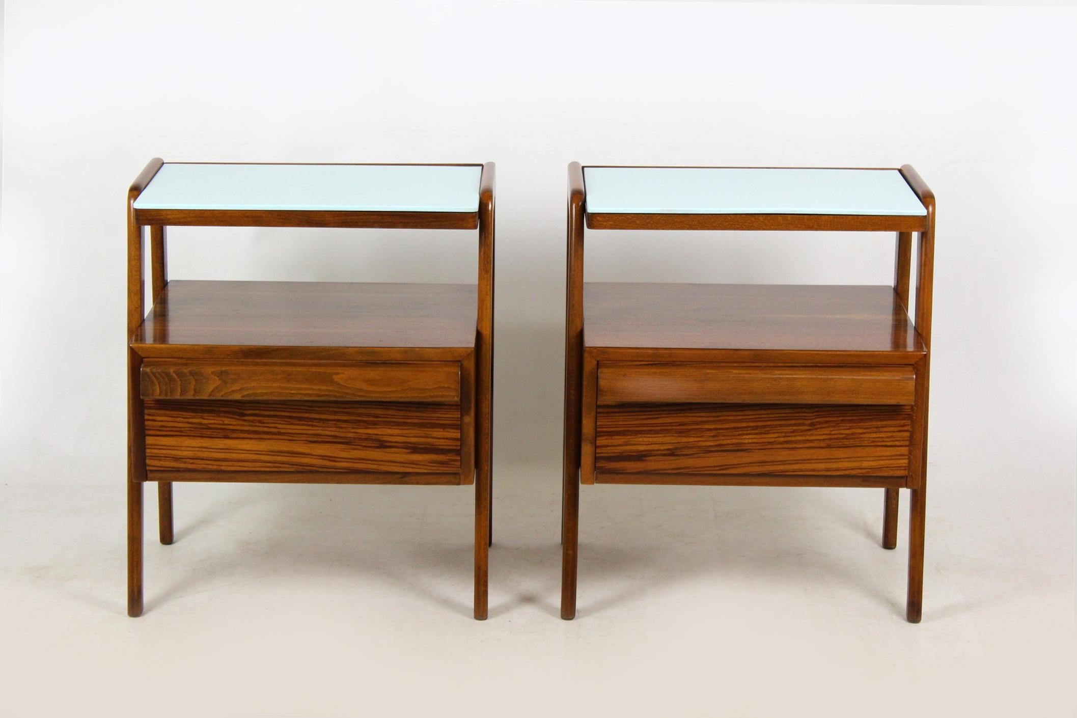 Pair of Mid-Century Modern nightstands, manufactured by Jitona in 1960s.
Nightstands kept in good, vintage condition, features original light blue glass on the tops.