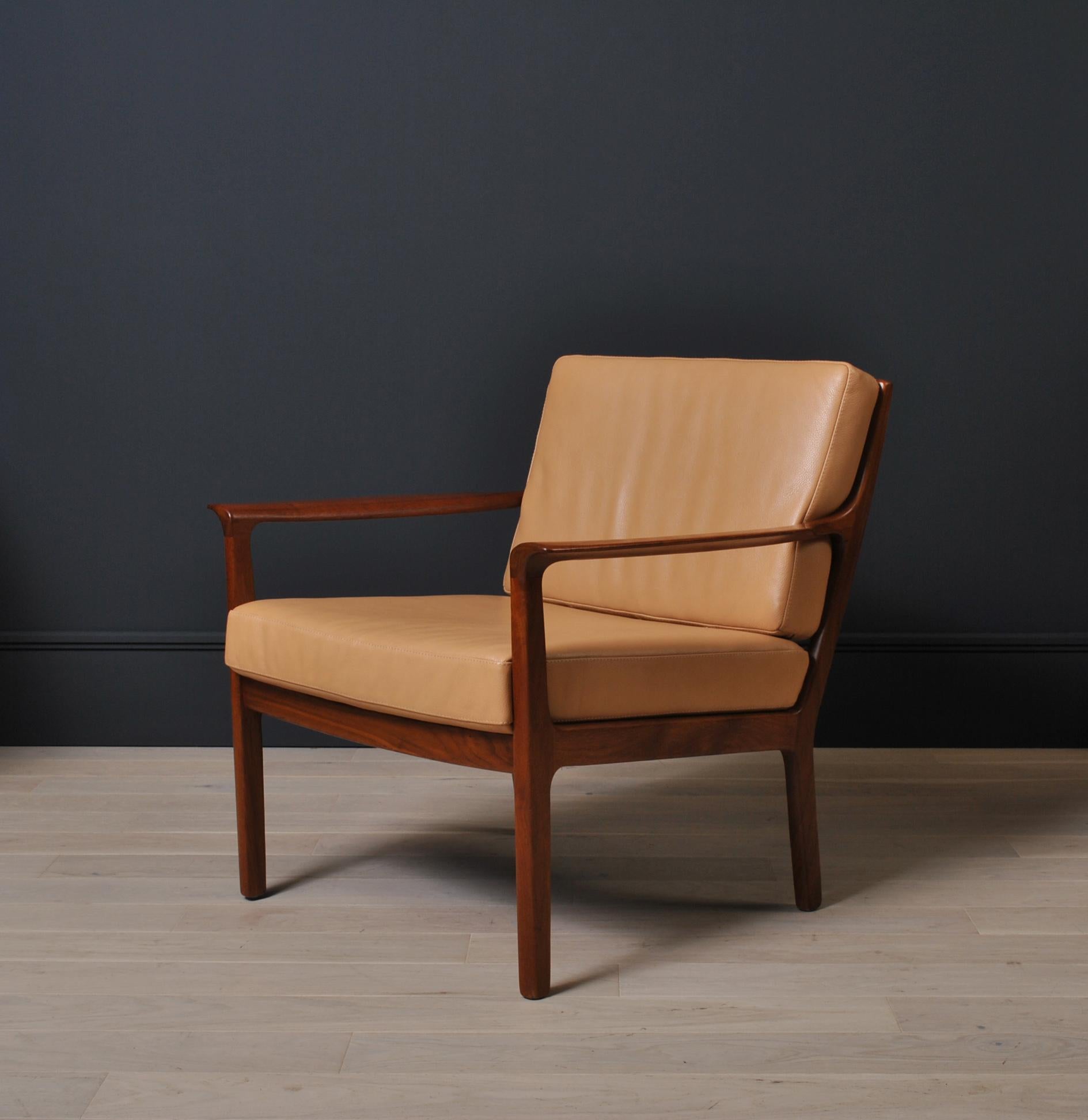Elegant Nordic 1960’s midcentury lounge chairs constructed from rich brown teak fully reupholstered in soft tan leather. Curved sweeping sculpted arms. More available with alternative upholstery options.