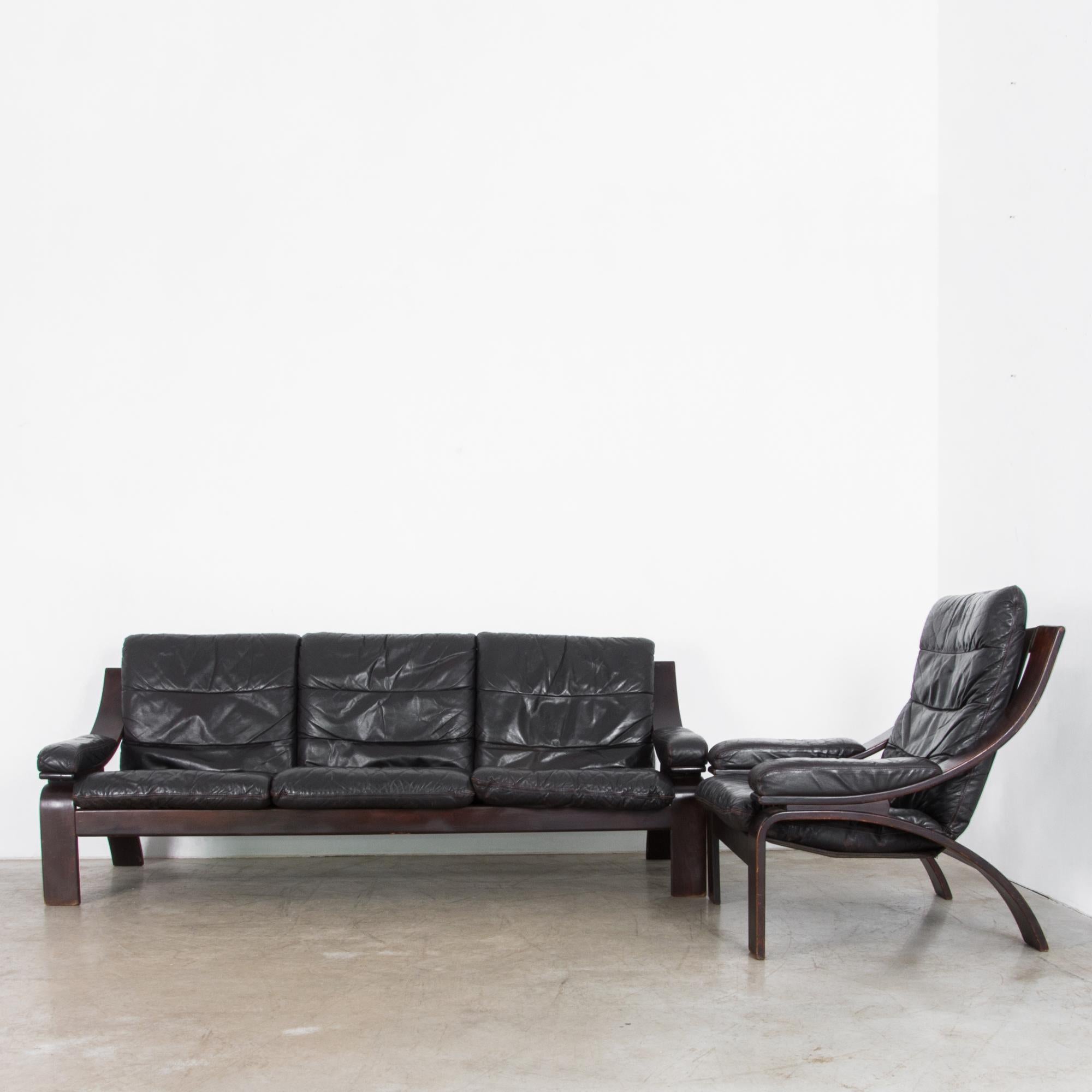 This black leather sofa and armchair set were made in Norway in the 1970s. The clean curves of the bentwood frame are both fluid and minimalist, showcasing the elevated simplicity for which Scandinavian Modernism is known. Craftsmanship and design