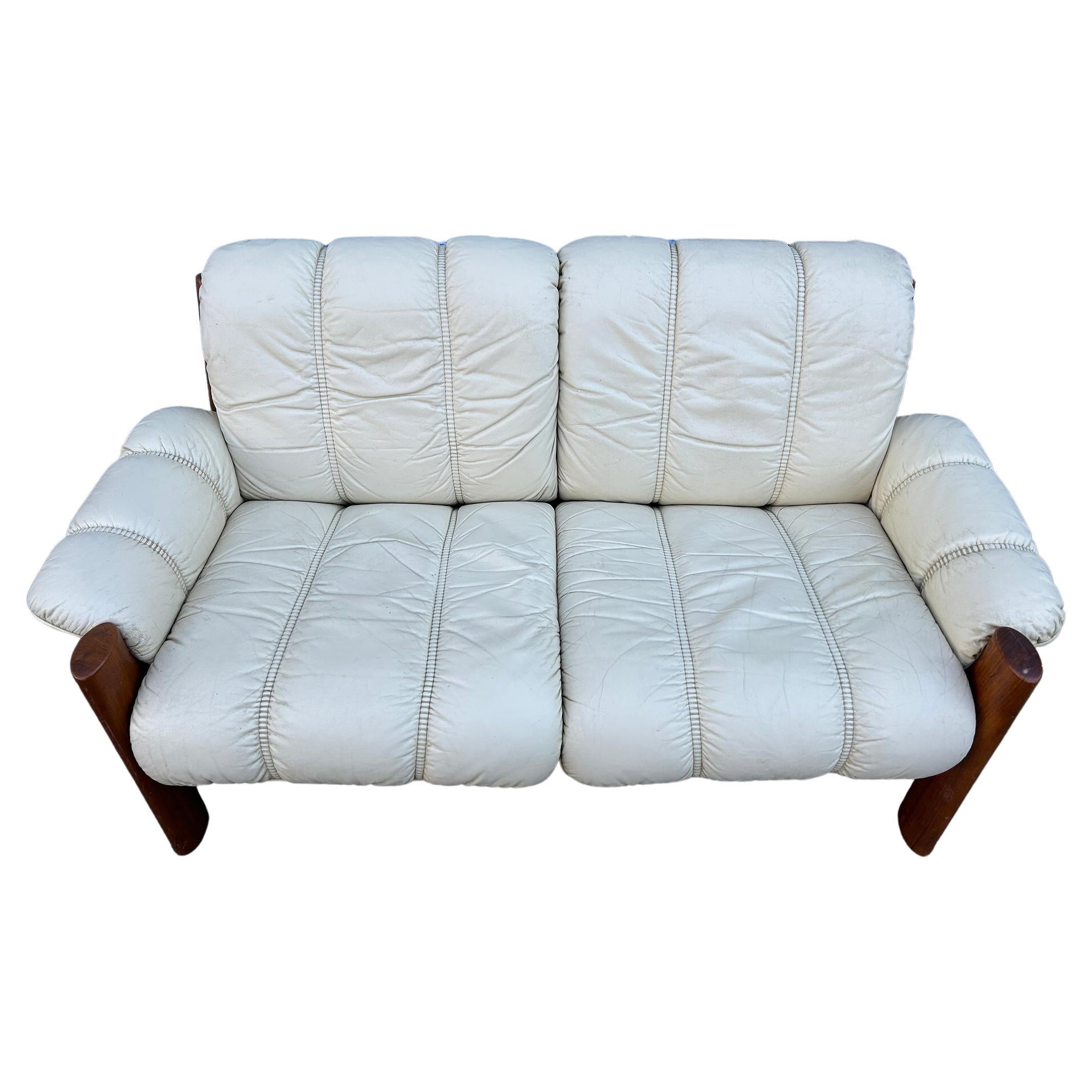 Mid-century Norwegian Modern Ekornes leather teak 2 seater sofa. Superb light buttermilk yellow/beige leather with solid teak wood frames. Beautiful condition and very comfortable. Great Norwegian Design. Good Vintage condition shows normal wear -