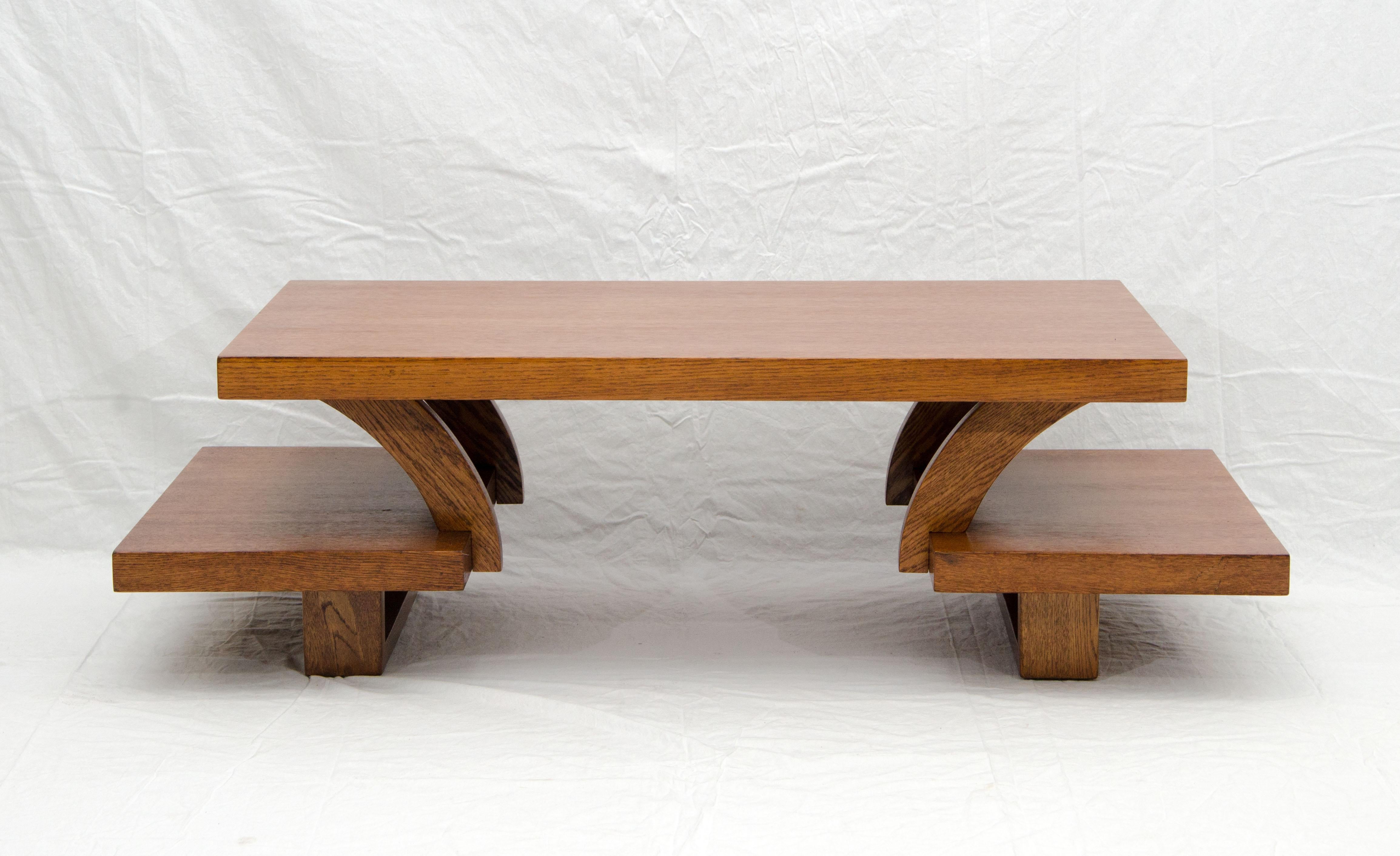 Interesting and unusual design for this 1950s oak coffee table with extended half shelves at both ends. The small shelves at each end are 7 1/4