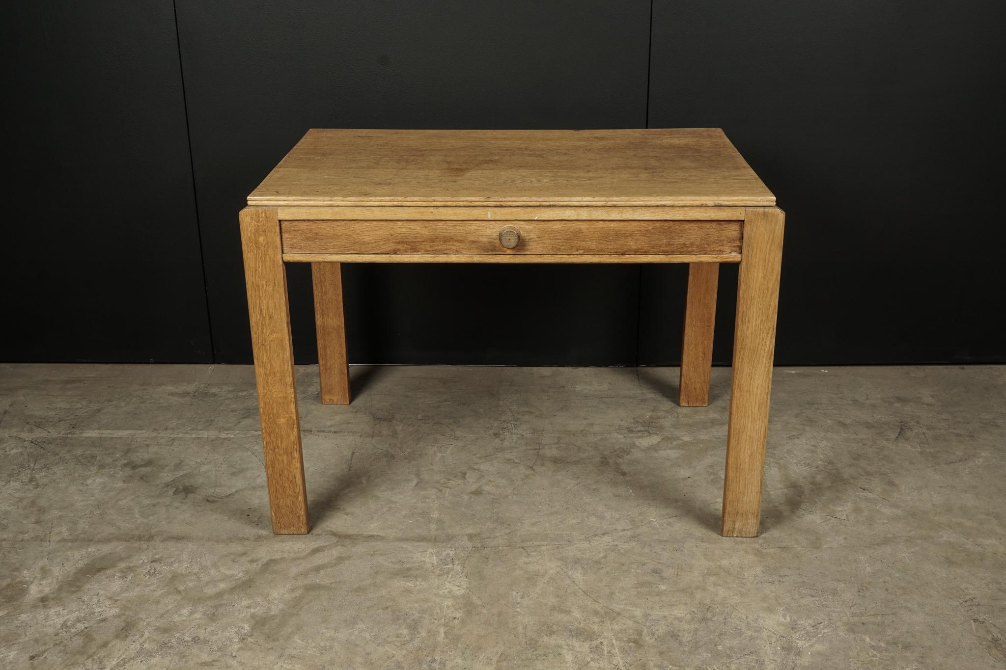 Midcentury oak desk From France, circa 1960. Solid oak construction with drawer. Original manufacturers label on the inside drawer from Lyon, France.