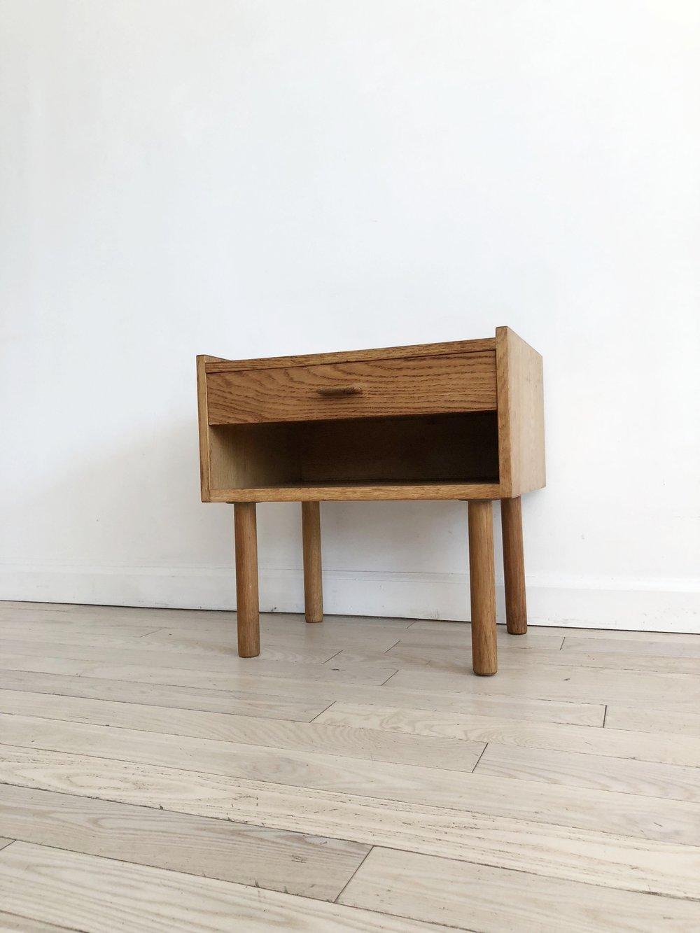 Wonderful oak bedside table with cubby and single drawer designed by Hans J. Wegner for Ry Mobler, Denmark. Cubby height is 3.85 inches. Beautiful cylinder legs, Wegner staple. Solid oak, even the drawer. Finished on all sides, great for a side