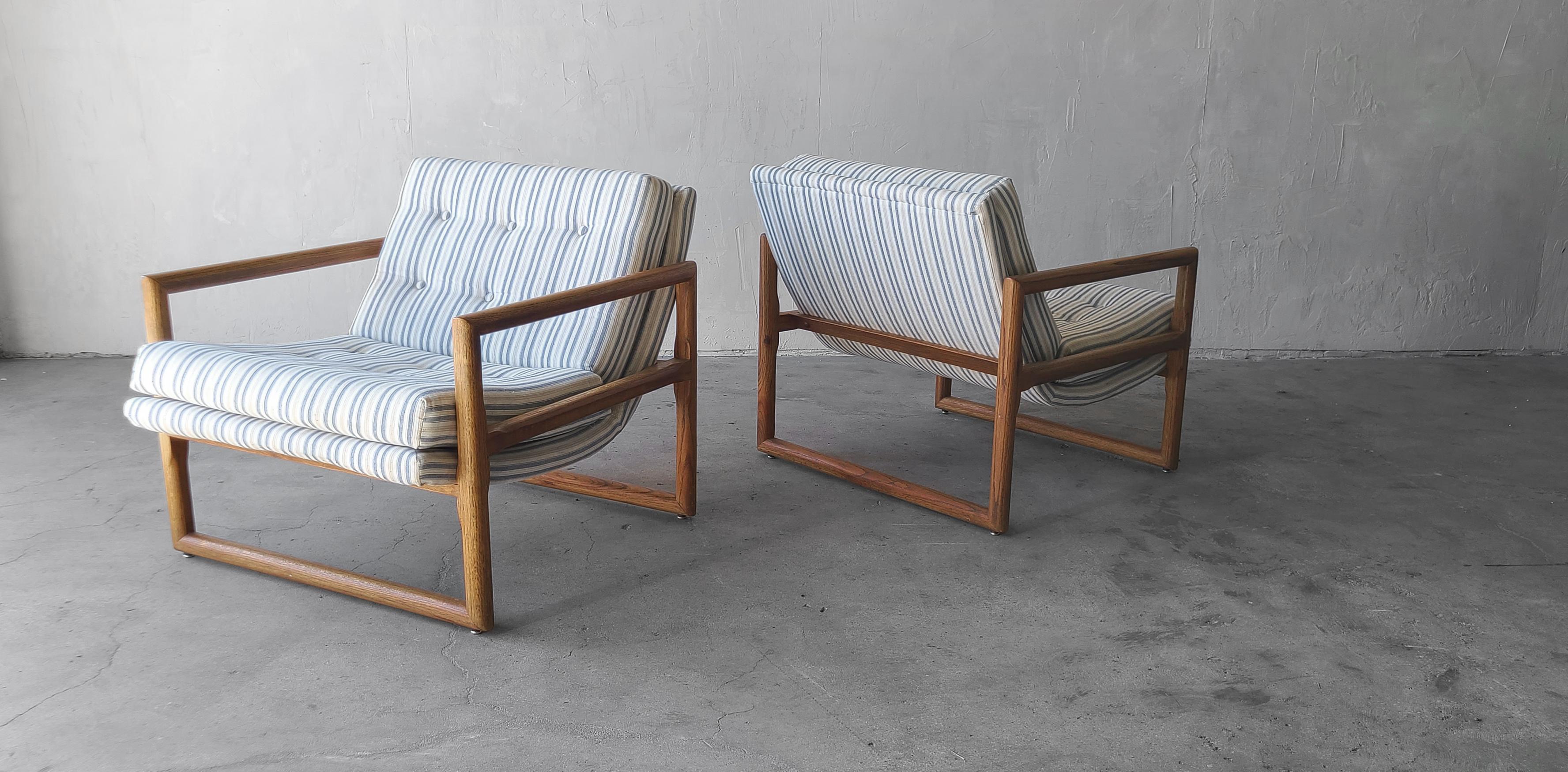If you're looking for the perfect pair of Minimalist lounge chairs, look no further. This beautiful pair of oak Milo Baughman style scoop chairs are the perfect, simple clean line chairs for any decor space.

These chairs are structurally sound