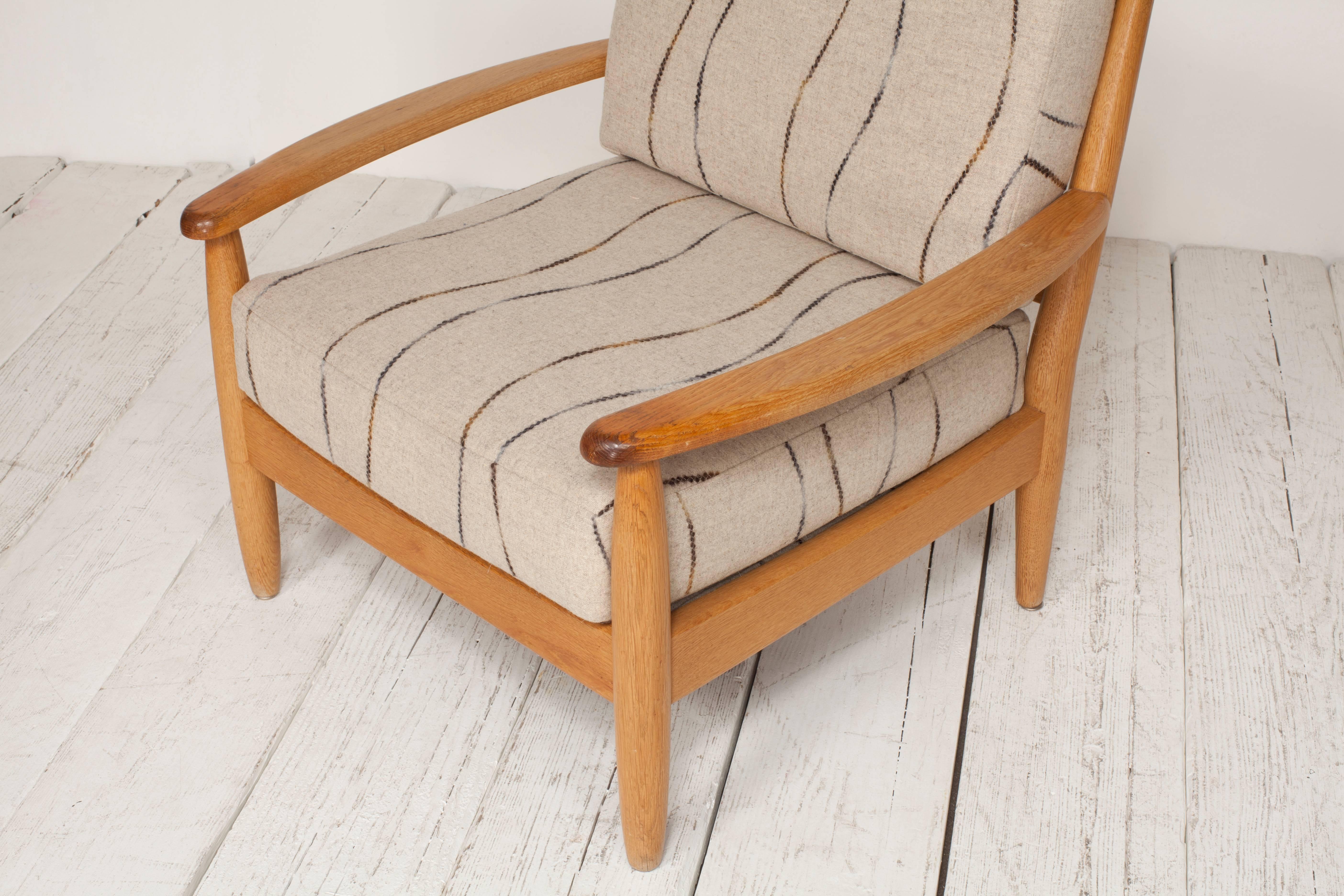 Midcentury oak spindle chair newly upholstered in grey wool fabric.