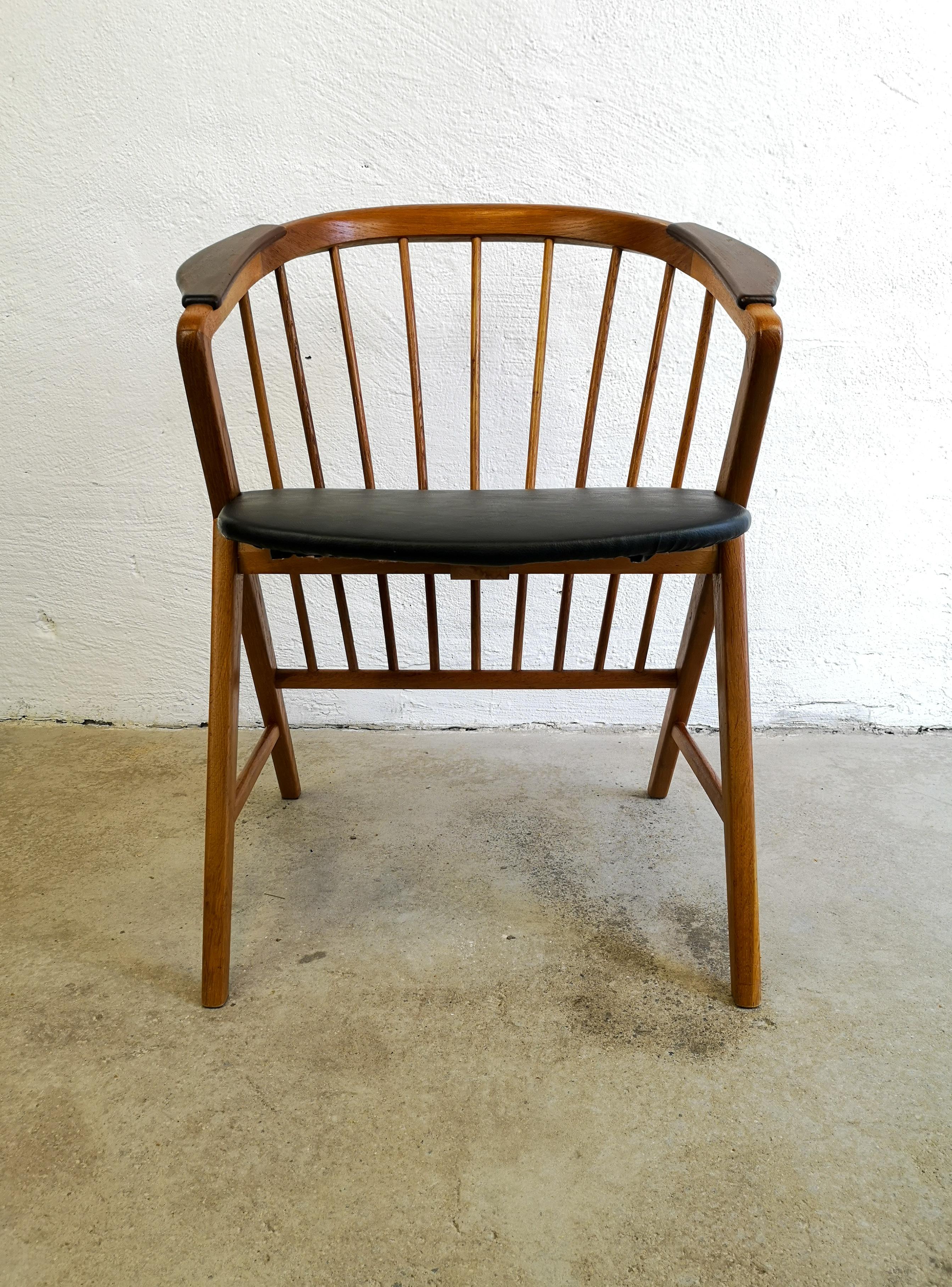 This chair was designed by Bengt Ruda 1959 and produced by Ikea Sweden. It made of oak with armrests made in teak. This one is considered a Classic piece for Ikea. The seat has been redone with leather imitation. 

Good vintage condition with some