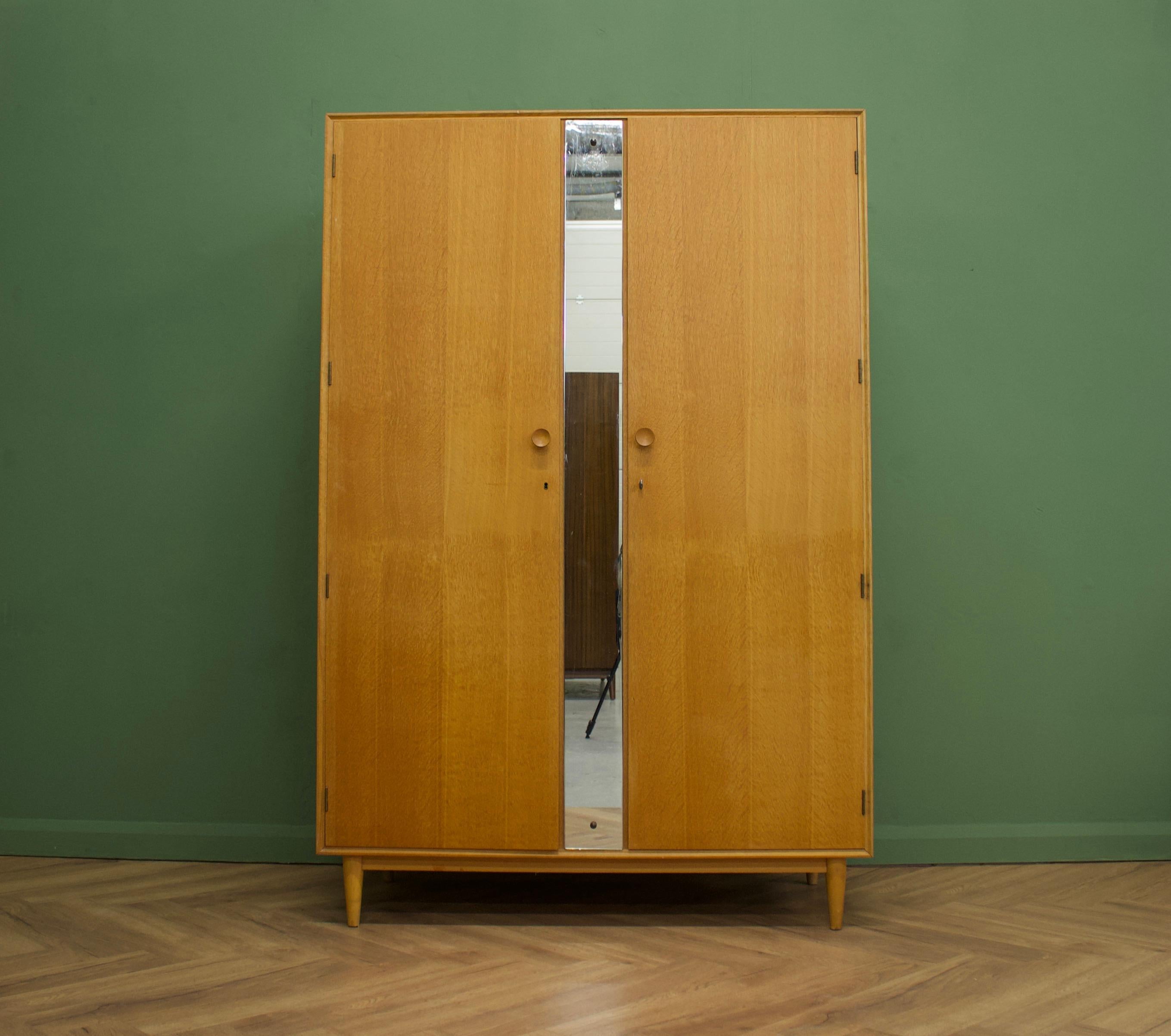 Midcentury wardrobe
Manufactured in the UK by Meredew
Made from oak and oak veneer.

Featuring solid oak handles, a rail and full length mirror.