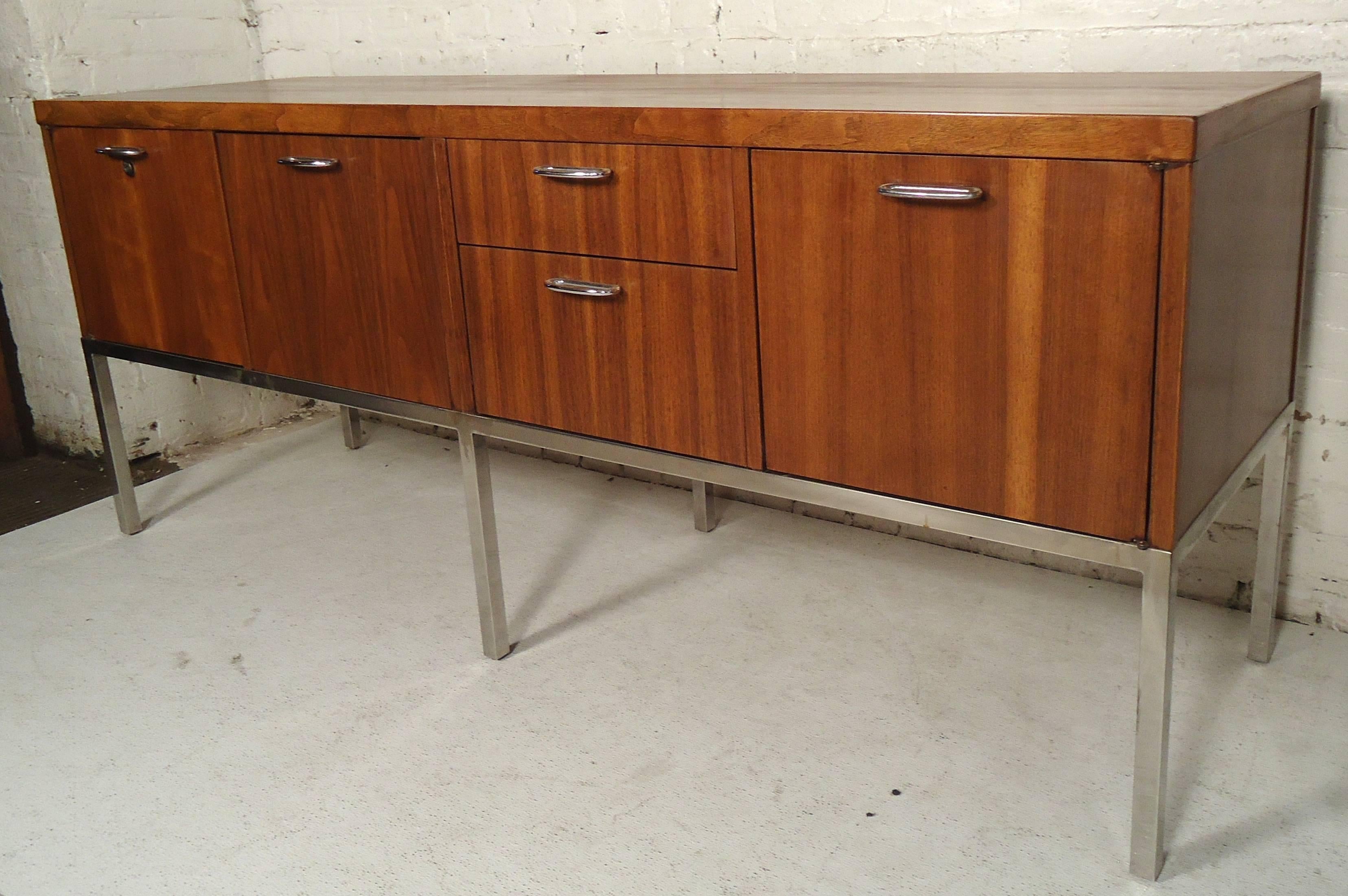 Executive desk and cabinet made by Directional. Features warm walnut grain and polished chrome legs and trim. Ample storage and finished backs.
Measures: Desk 62