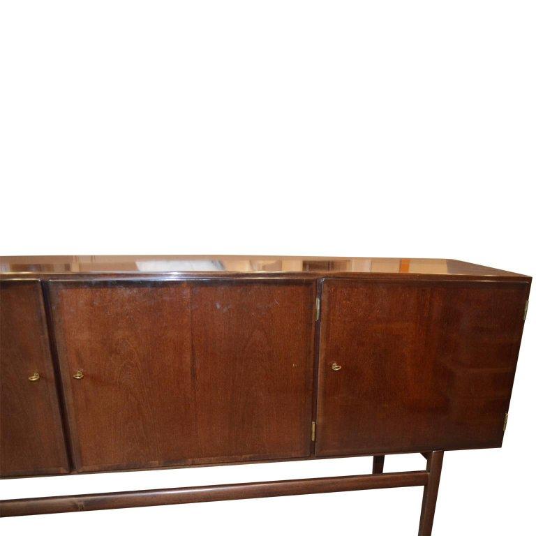 Mid-Century Ole Wanscher Sideboard
Ole Wanscher designed this clean-lined sideboard for Poul Jeppesen in the 1960s. Constructed of a rich stained mahogany, the raised case features three locking doors (with the original brass key) that conceal