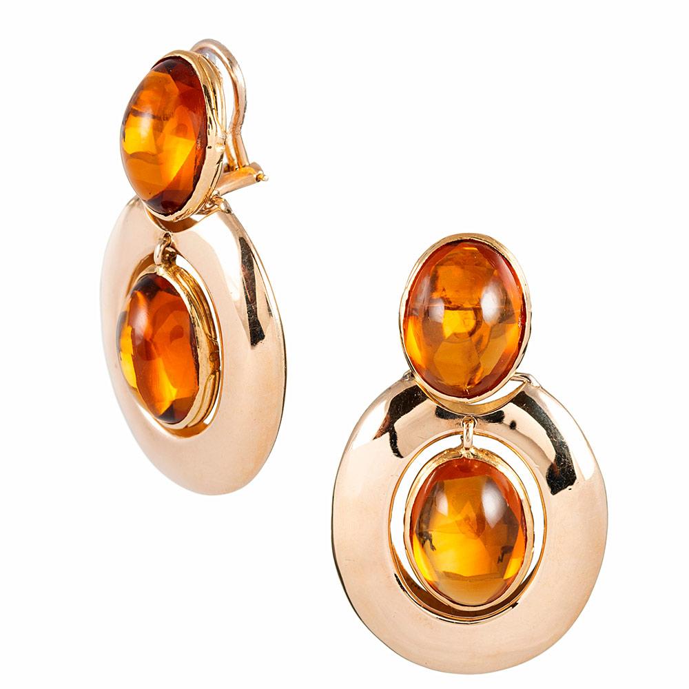 High-polished oval strokes of 14 karat yellow gold receives a rosy cast from the cabochons of citrine set inside their borders. These earrings are fun, sophisticated and easy to wear for any occasion. They measure 1.75 inches long. Currently clips,