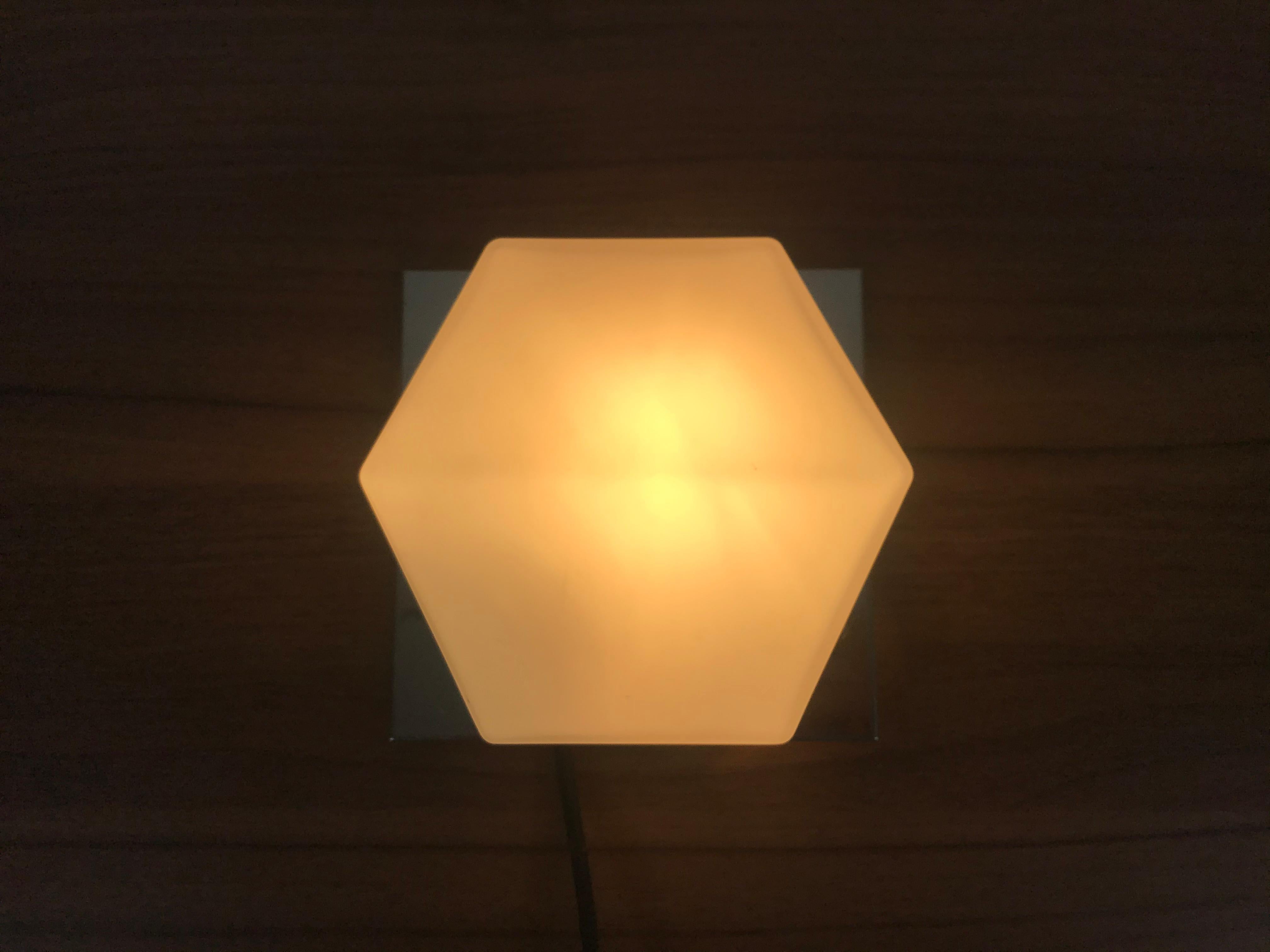 A beautiful Mid-Century Modern wall lamp by Glashütte Limburg made in Germany in the 1970s. It has a beautiful rectangle shape and is made of aluminium and opaline glass. 

The light requires one E14 light bulb.