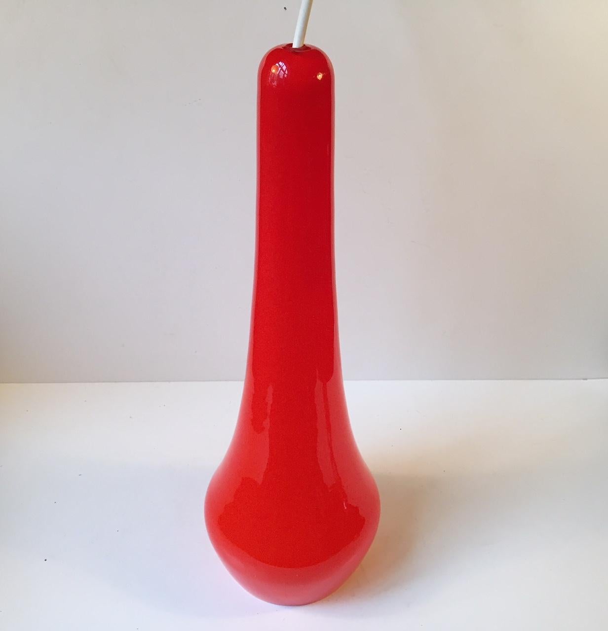 A tall organically shaped pendant lamp in cased orange glass. It was possibly designed by Gino Vistosi. Please notice that it has a few flee-bites - niks to the inside of the shade at the bottom.