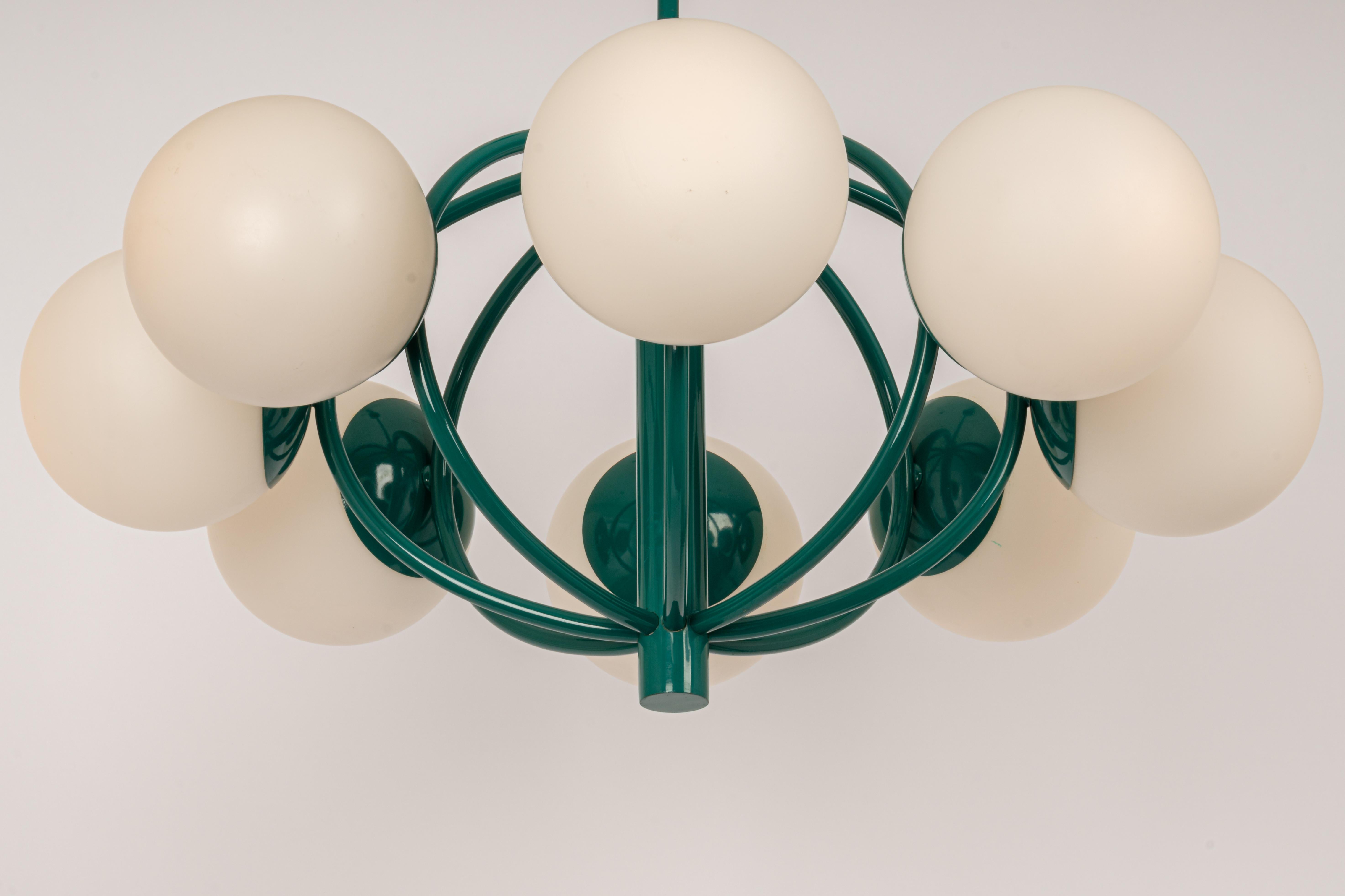 Midcentury vintage pendant in green color made by Kaiser Leuchten, Germany with 8 opal glass balls.
High quality and in very good condition. Cleaned, well-wired and ready to use. 

The fixture requires 8 x E14 small bulbs with 40W max
