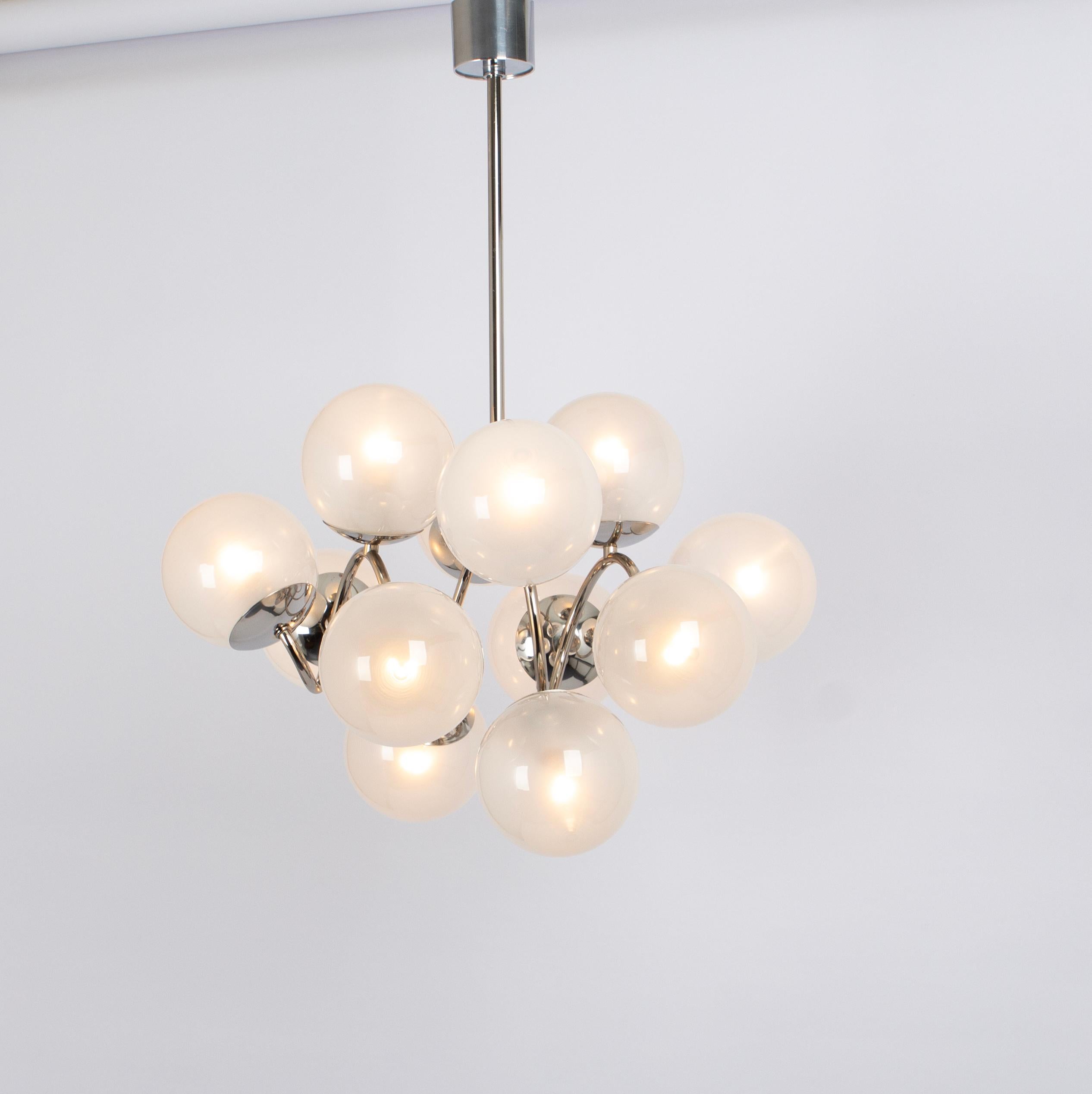 Midcentury vintage chrome pendant made by Kaiser Leuchten, Germany with 12 opal glass balls.
High quality and in very good condition. Cleaned, well-wired and ready to use. 

The fixture requires 12 x E14 small bulbs with 40W max each.
Light bulbs