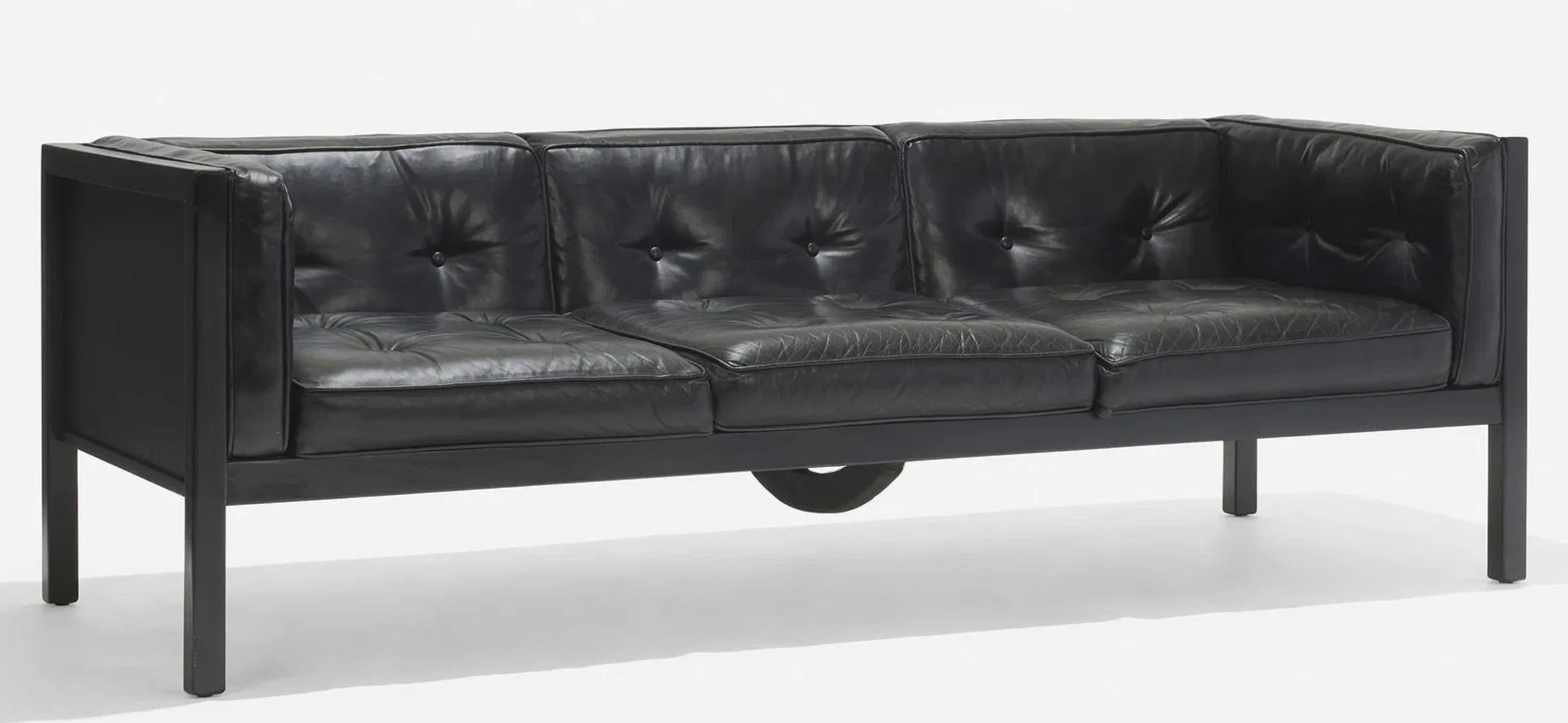 George Nelson & Associates for Herman Miller. The three-seater sofa with the original black leather upholstery with button tufting and elastic strapping set into an ebonized birch wood frame 

Ask for custom shipping quote from Brooklyn, NY.

Model