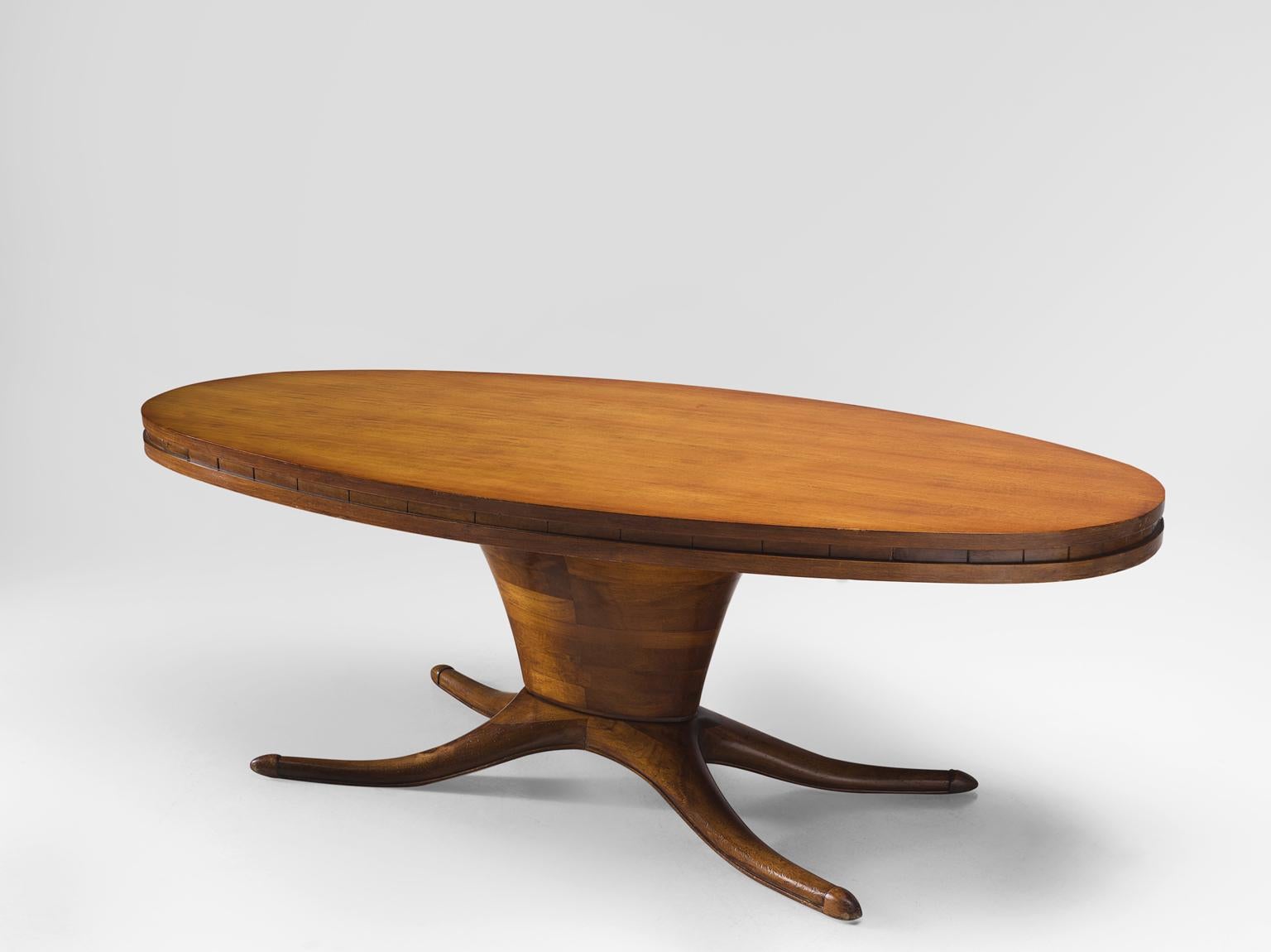 Dining table, walnut, Italy 1950s.

This oval dining table is executed in walnut veneer. The most striking detail of this table is the leg that is divided into a biomorphic foot. This element, combined with the oval base and oval top makes an