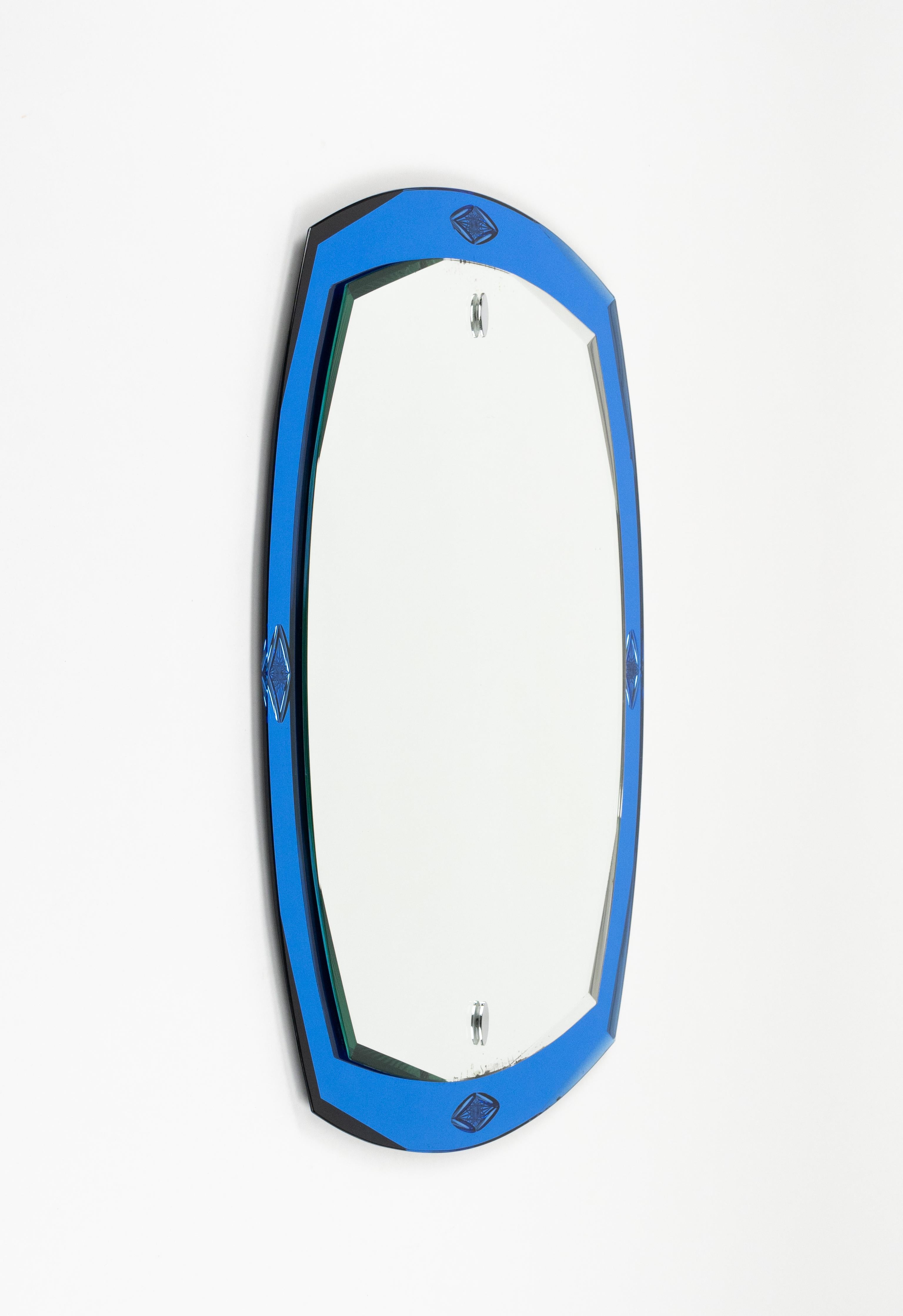 Midcentury amazing oval wall mirror with a blue mirrored border in the style of Crista Arte.   

Made in Italy in the 1970s.   
  
The mirror would be perfect for a bedroom, dressing room, cloakroom or hallway.