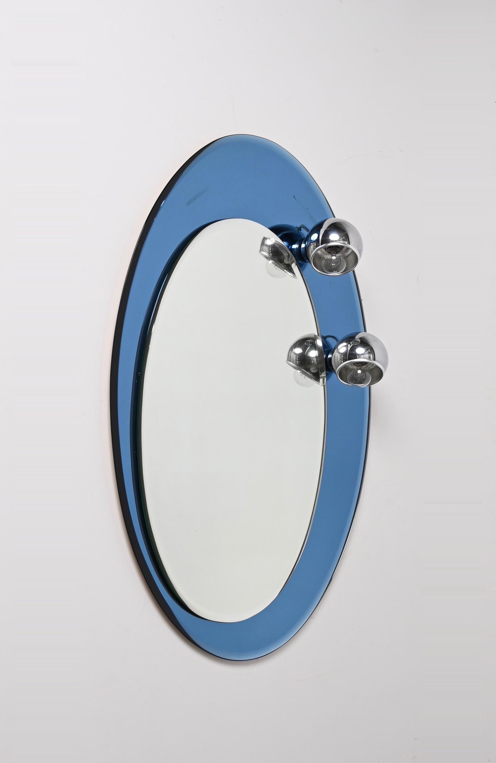 Midcentury Oval Wall Mirror with Blue Glass Frame and Magnetic Lights Italy 1960 In Good Condition For Sale In Roma, IT