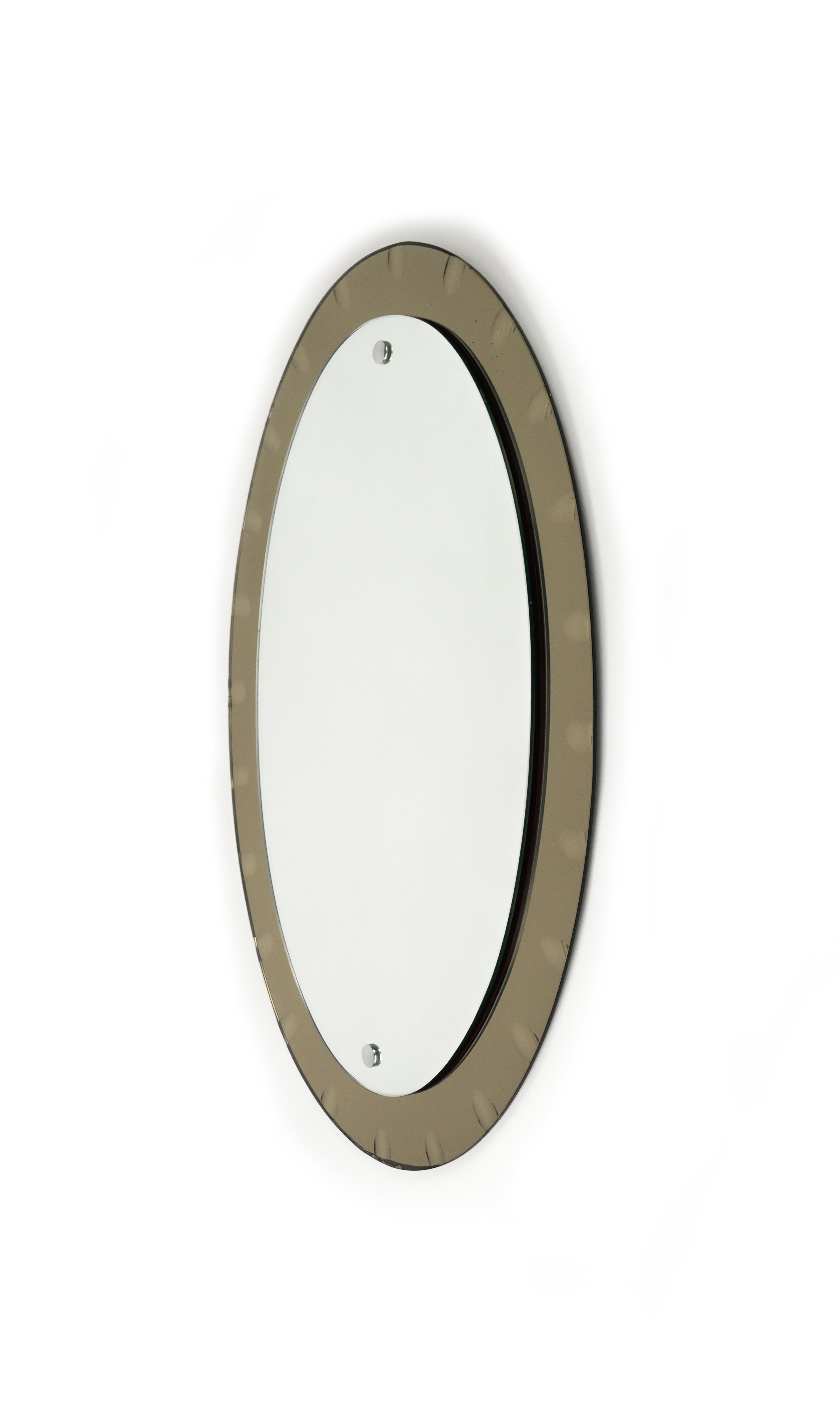 Midcentury amazing oval mirror the production of which can be attributed to Cristal Arte. 

Made in Italy in the 1960s.

The mirror has an oval shape and consists of two 5mm planes each. The mirror is anchored to a frame of the same shape, but