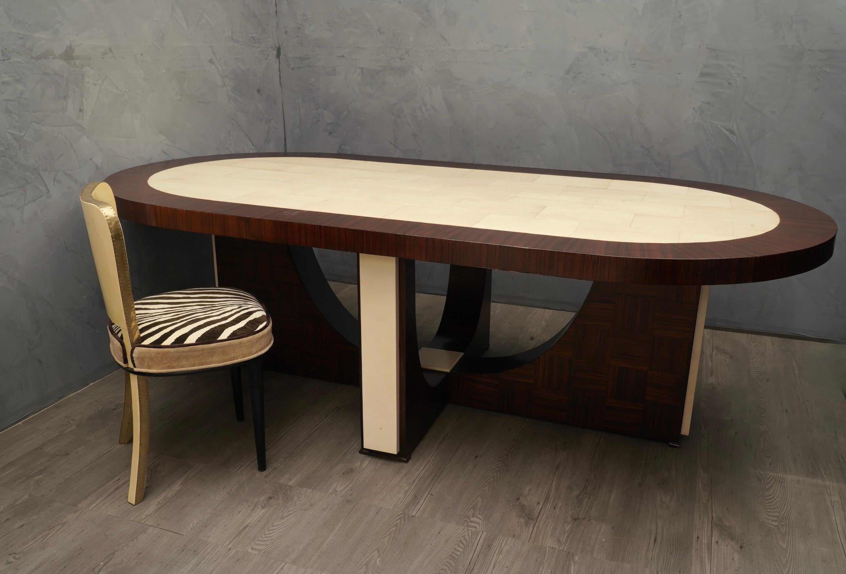 Clean lines and absolutely original shape for the leg with a very large tabletop, perfect for meetings in the office or in the family.

The tabletop is formed by a large zebrano wood veneered frame, with a goatskin covering in the center. Beautiful