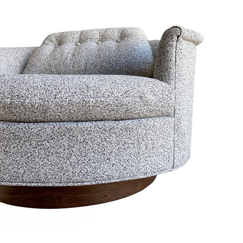 Gorgeous oversize swivel tub lounge chair by Selig Imperial, circa 1970s. Large scale round lounger rests on a walnut veneer plinth base. Supreme comfort. Excellent condition. Newly upholstered in a salt and pepper boucle and is ready for