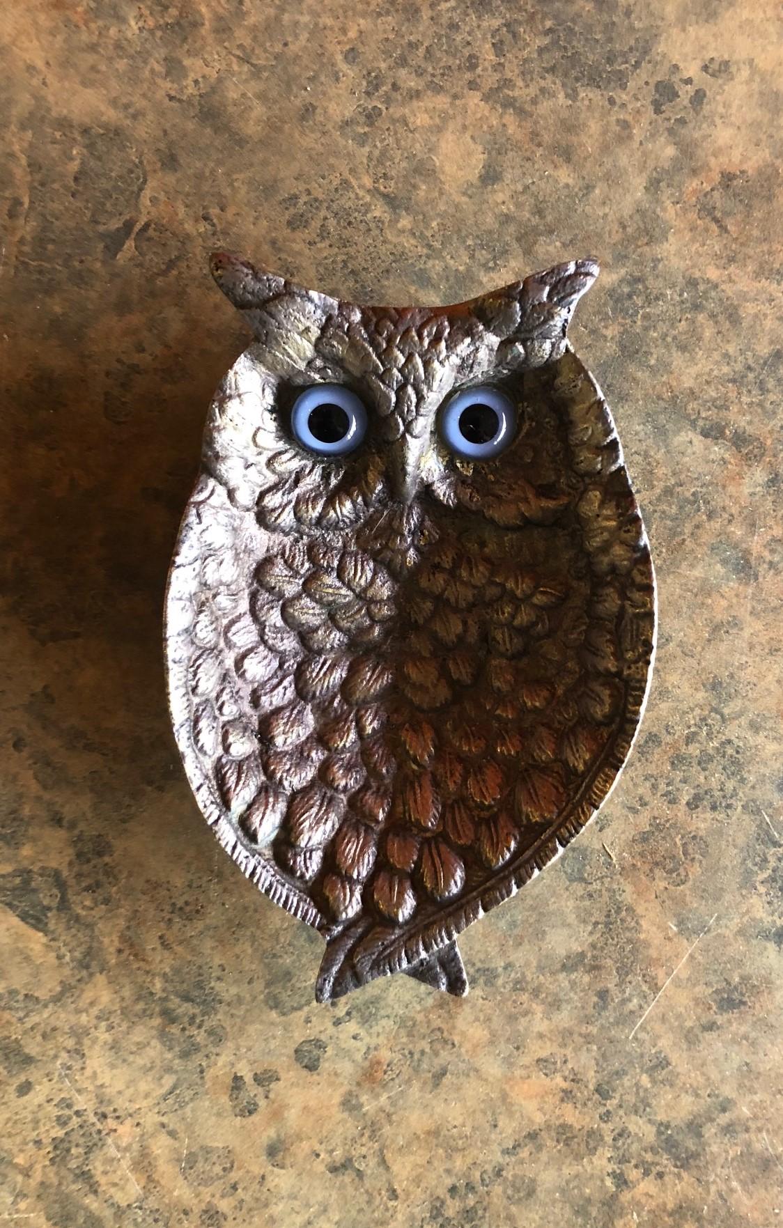 A very cool and unique midcentury pewter owl dish with striking blue eyes. The dish is very heavy and well made with a very small hallmark on the back.