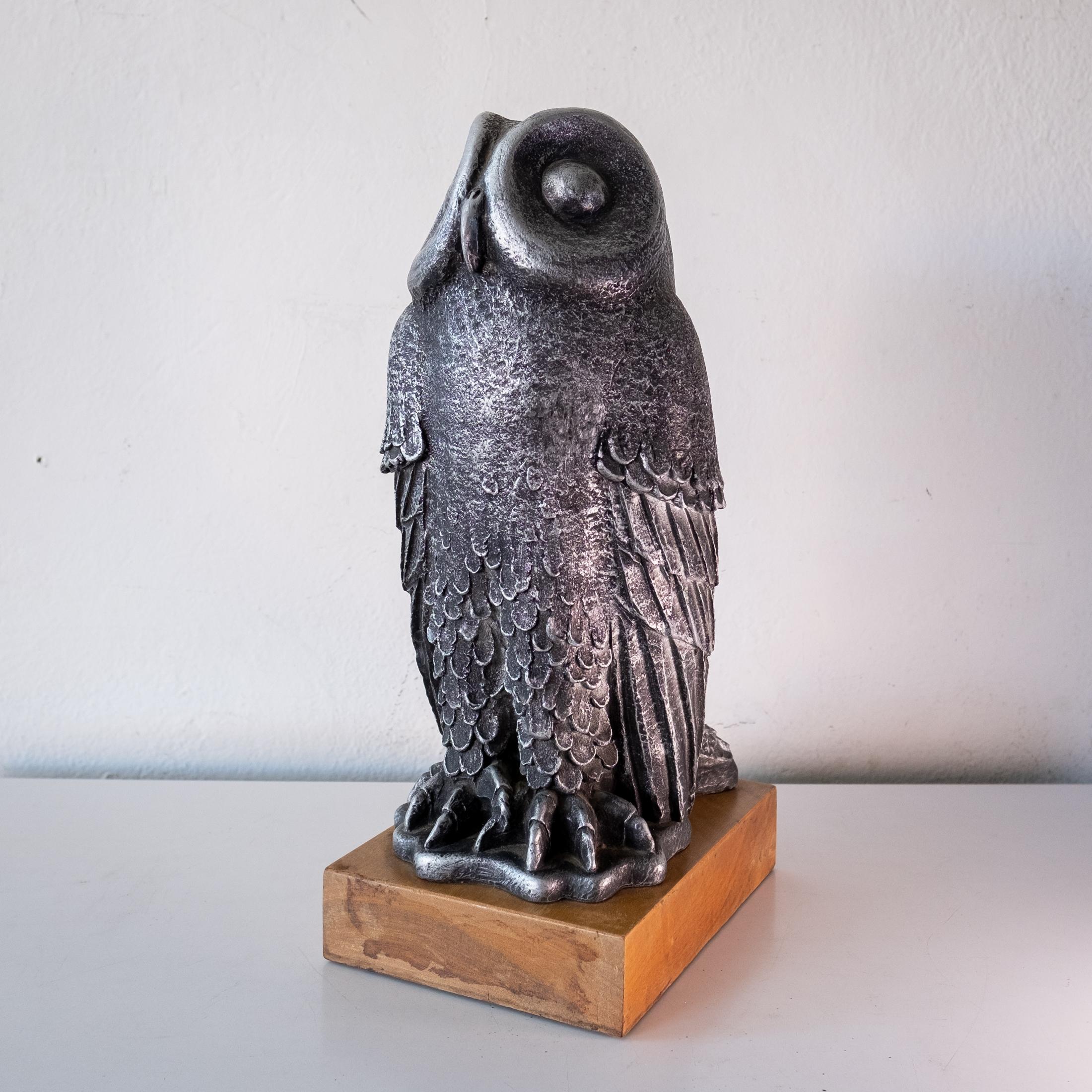 Mid-century owl sculpture by Paul Ballardo for Austin Enterprises. Large scale table top or mantle piece. Resin casted with a wood base. United States, 1971.
 