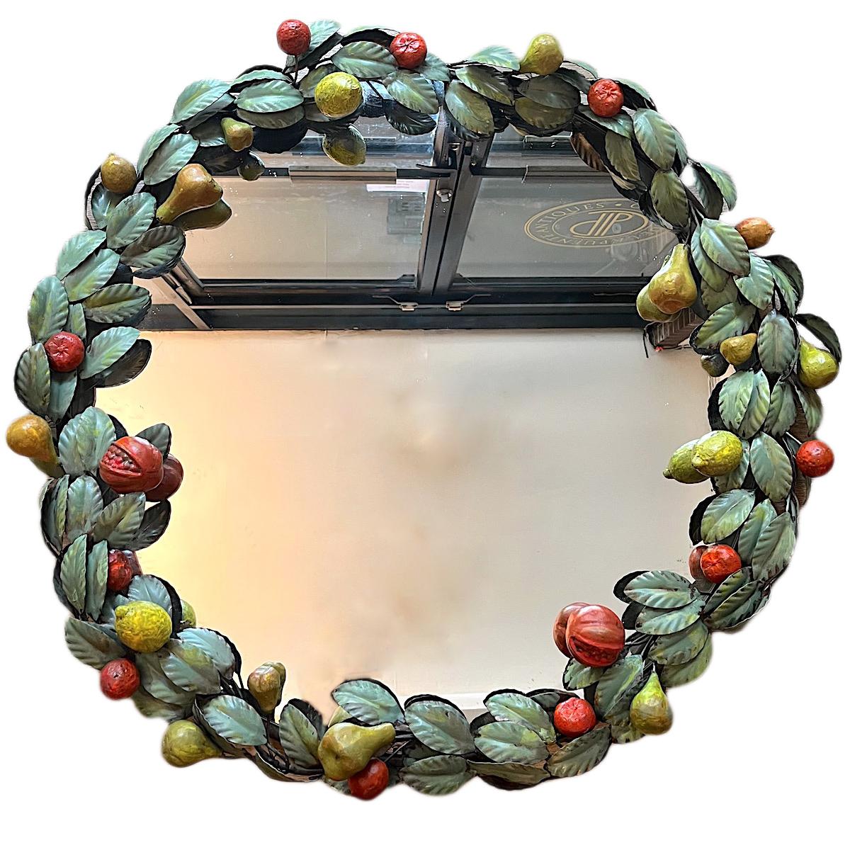 A circa 1950's Italian painted tole mirror with laurel leaves and fruits.

Measurements:
Diameter: 33.5