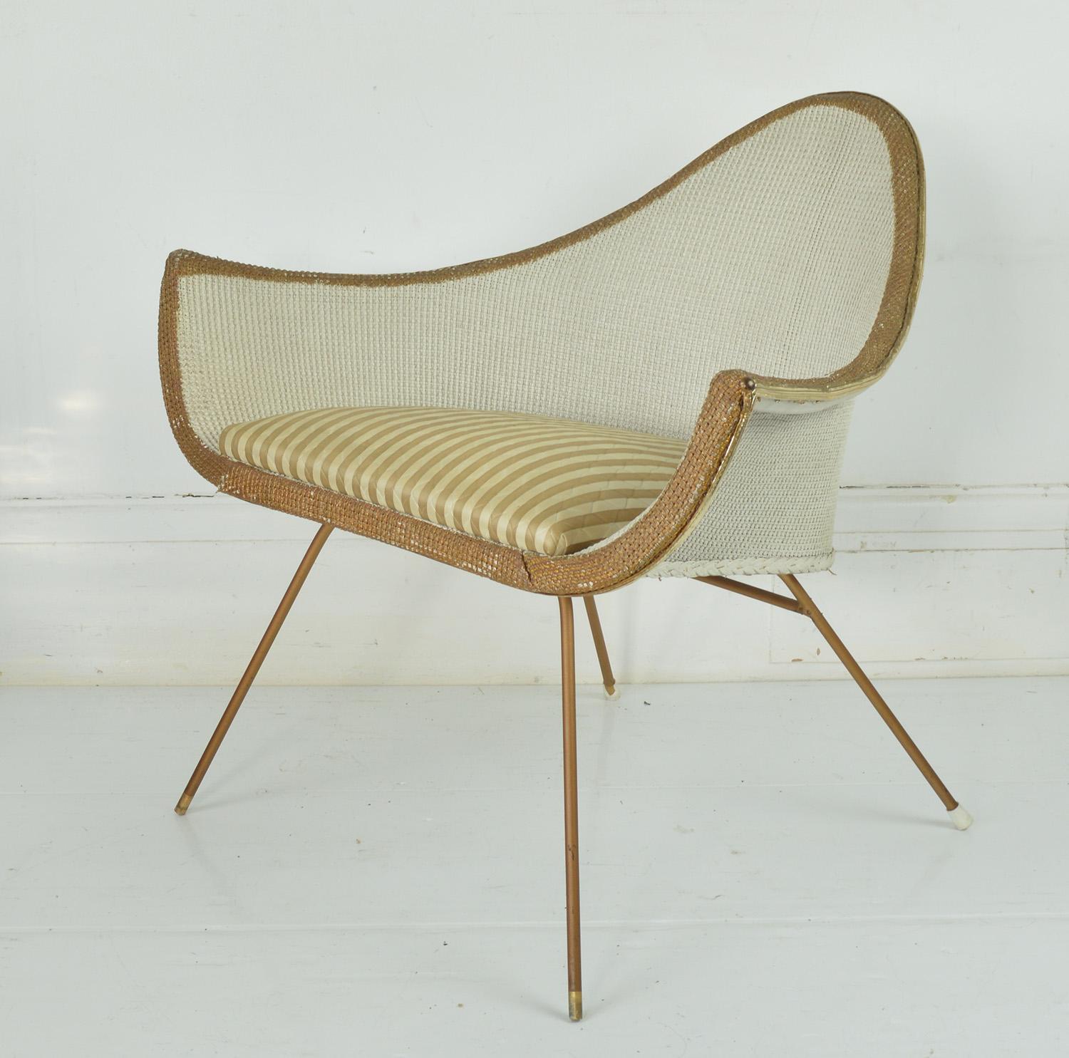 Very stylish chair. Such an amazing shape

The woven fibre is painted white and gold. It has been historically re-painted most likely in the same colors.

Gold vinyl trim. Metal supports.

The vinyl upholstery is original.
 