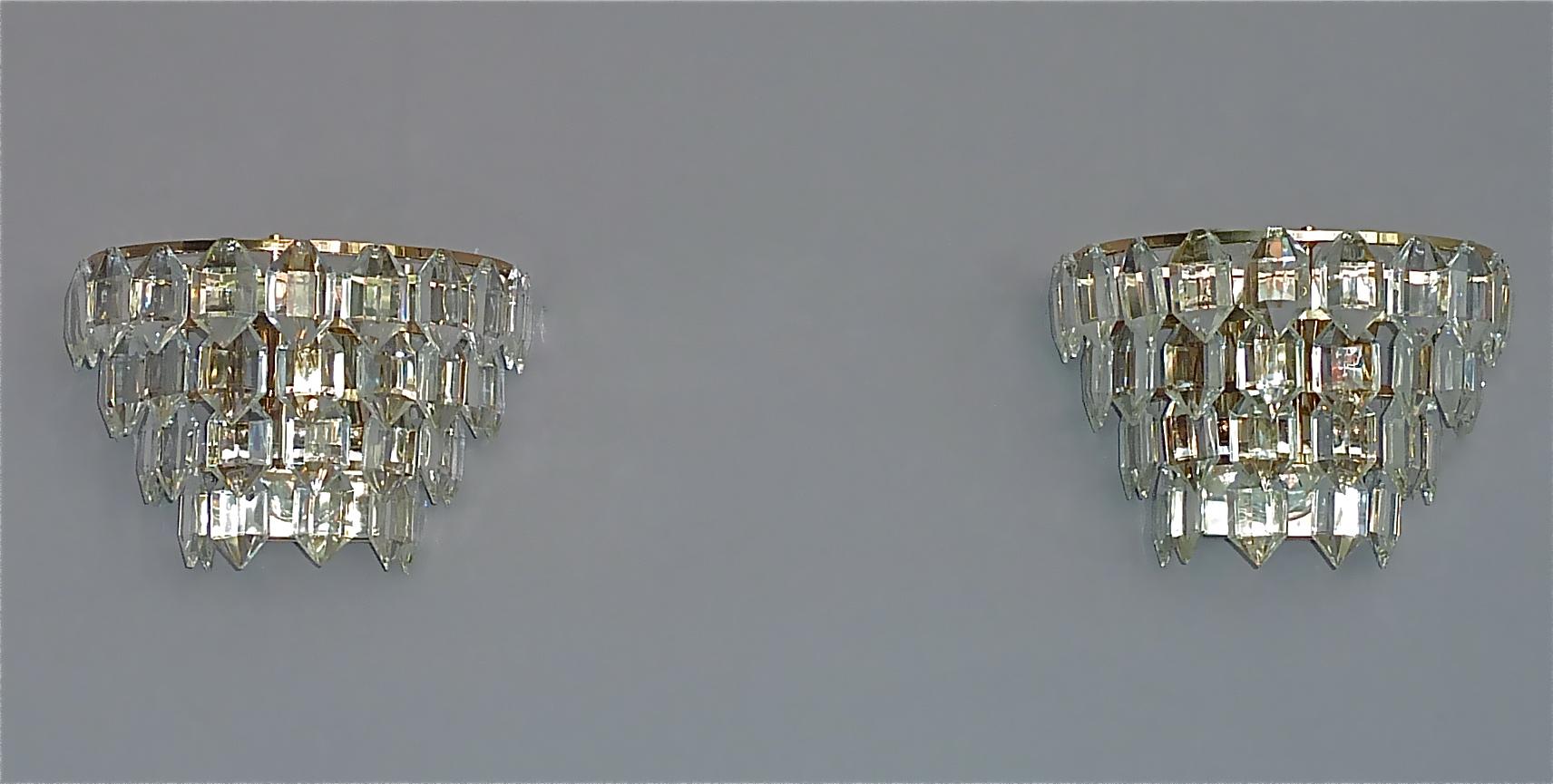 Beautiful midcentury pair of Bakalowits sconces or wall lamps, Austria, circa 1960s. The high quality lights are made of silvered brass metal with a very nice characteristic patina and faceted crystal glass. They are 25 cm / 9.84 inches wide, 16 cm
