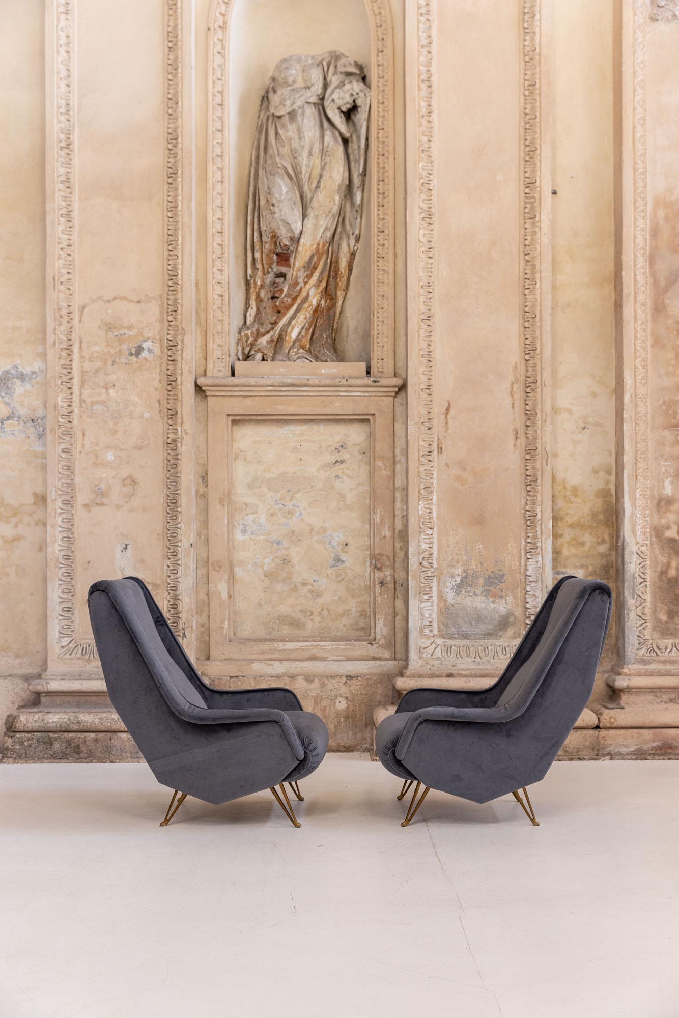 Stunning pair of ISA Bergamo armchairs, Italy 1950s.
Original shaped feet attributed to Gio Ponti.
The model is particularly comfortable thanks to the high back and the design. 
Newly reupholstered with blue velvet.
