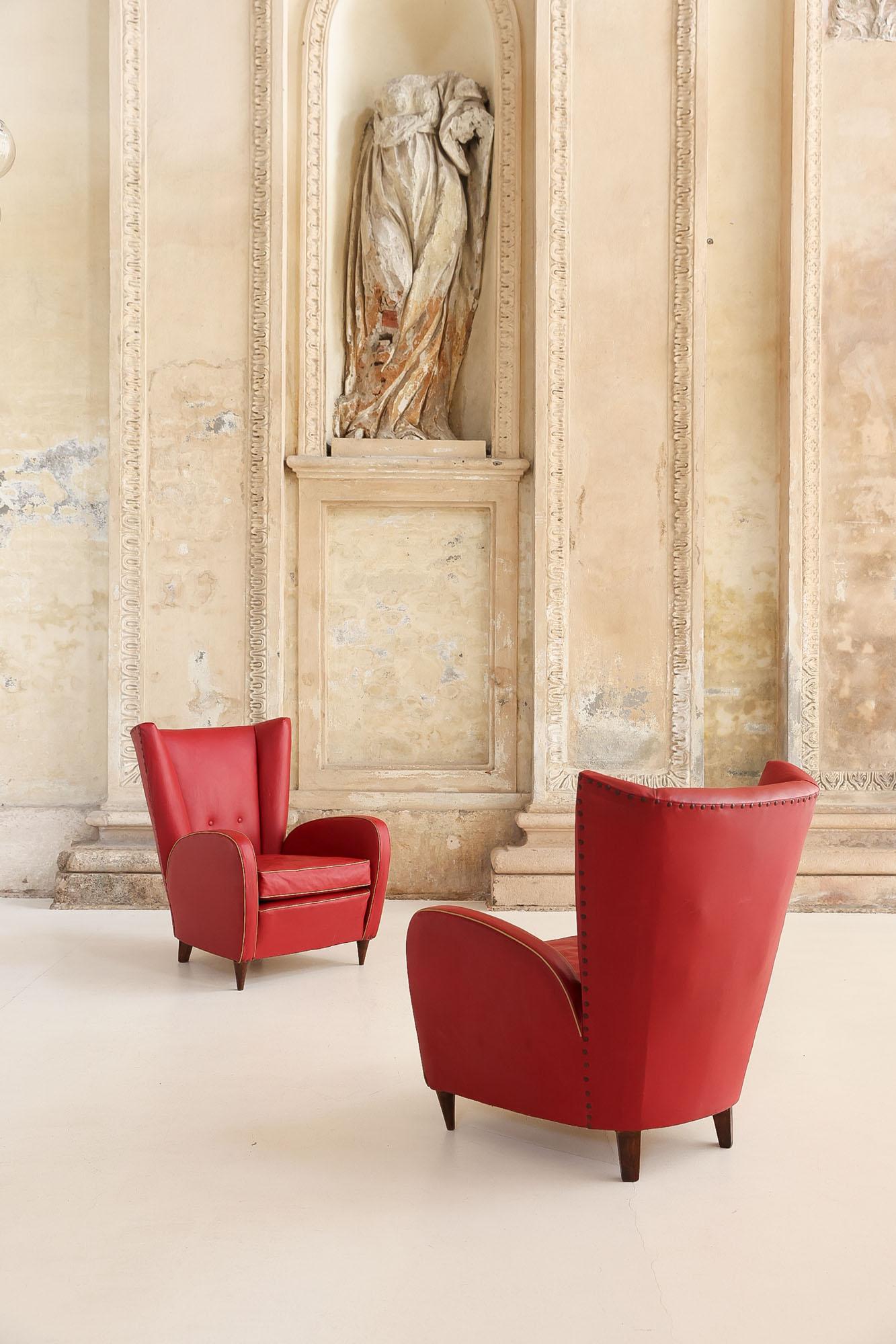 Iconic pair of high back armchairs with large seat and big armrest designed by Paolo Buffa 
Original structure, with red faux leather upholstery, perfect vintage condition 
Italy, 1940's 

Bilbio: Rizzi , Marelli, Novati “Mobili di Paolo Buffa”