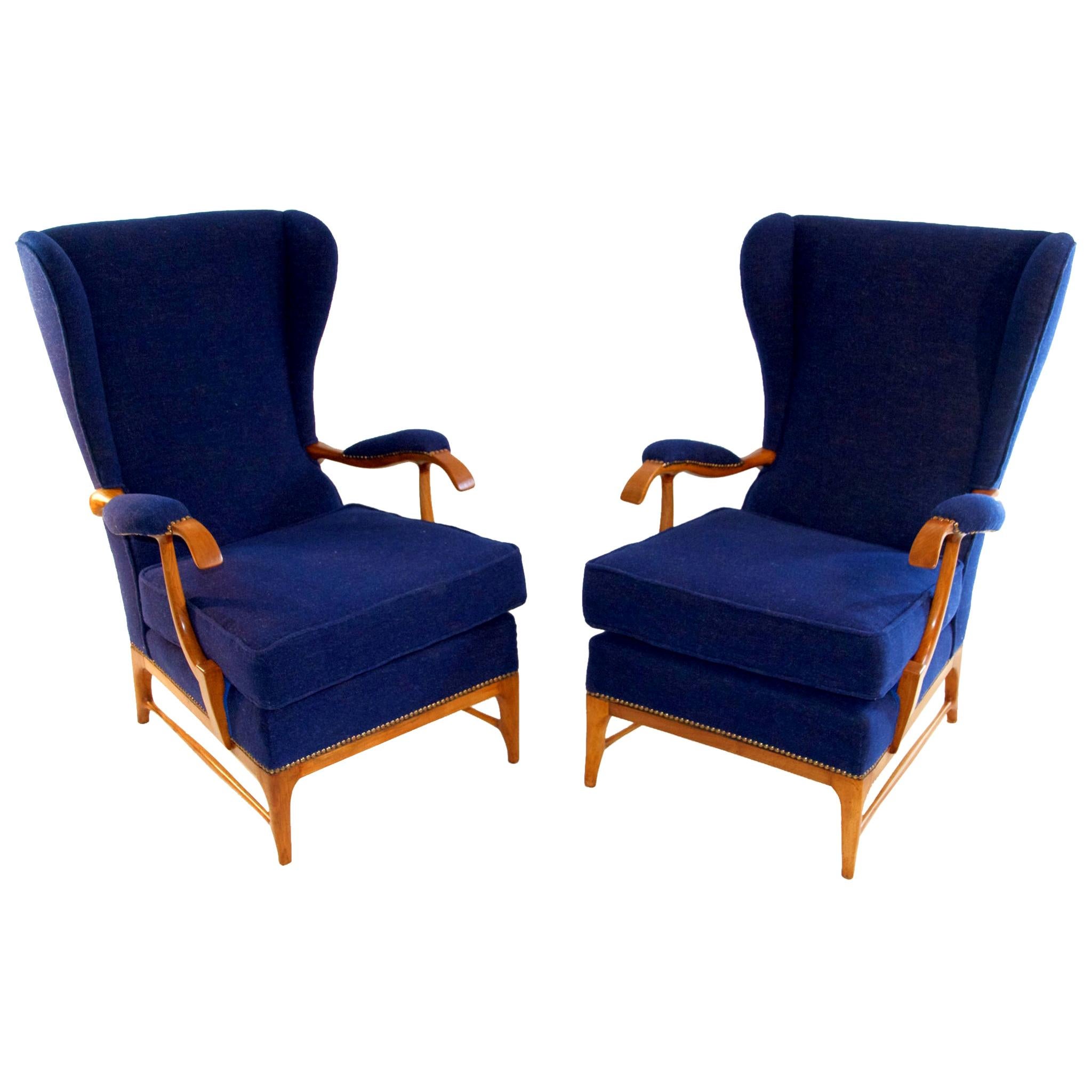Pair of wingback armchairs by Paolo Buffa with a wood frame in walnut and reupholstered in Italian blue wool.
Paolo Buffa is an Italian designer and architect. He is one of the most prolific designers from the 20th century.
His work is the