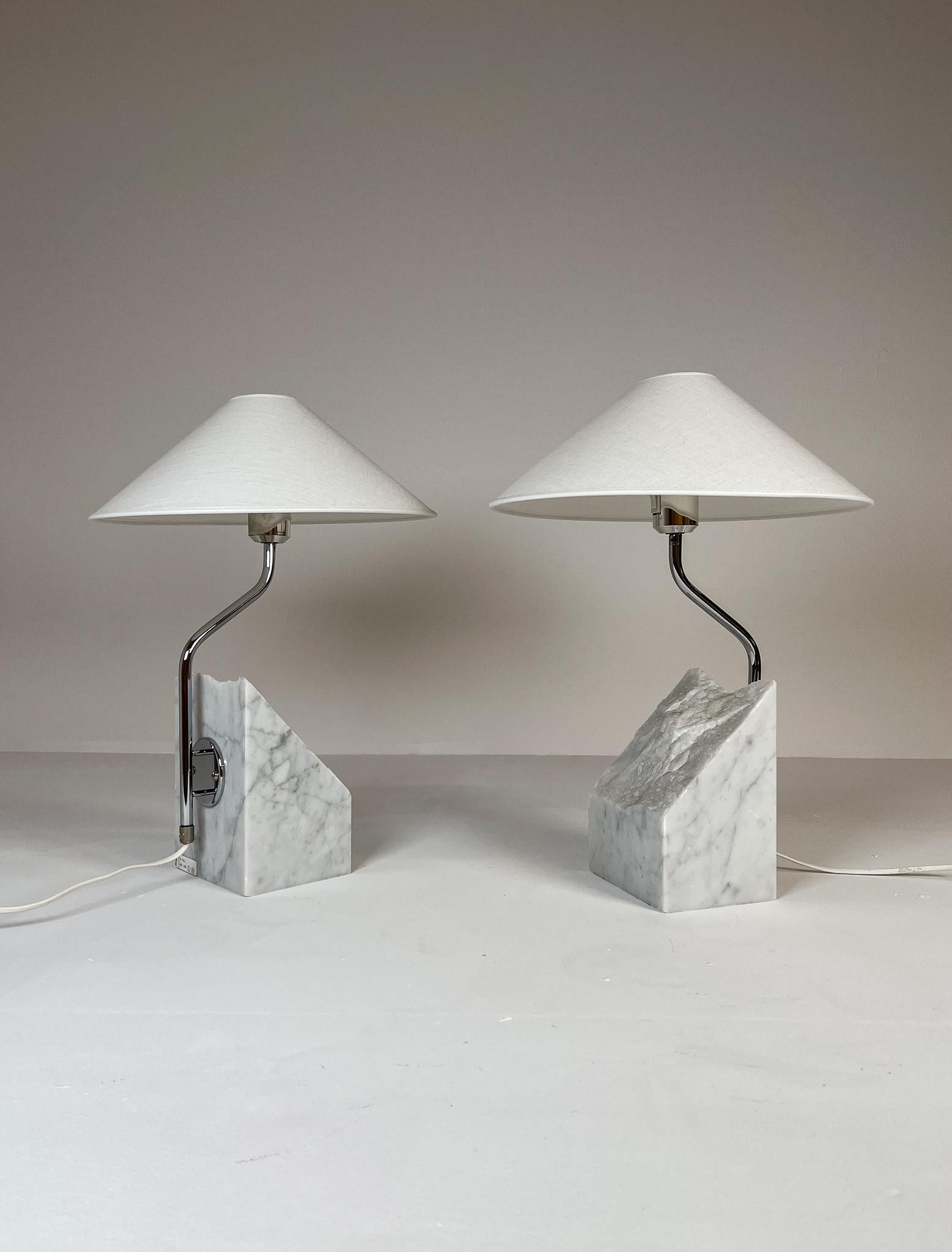 Large and heavy pair of marble stone table lamps with chromed steel arms. Bergboms design with all new cotton shades, made in Sweden This pair of table lamps will give that great look to a vintage home or a twist to the modern home. This pair with
