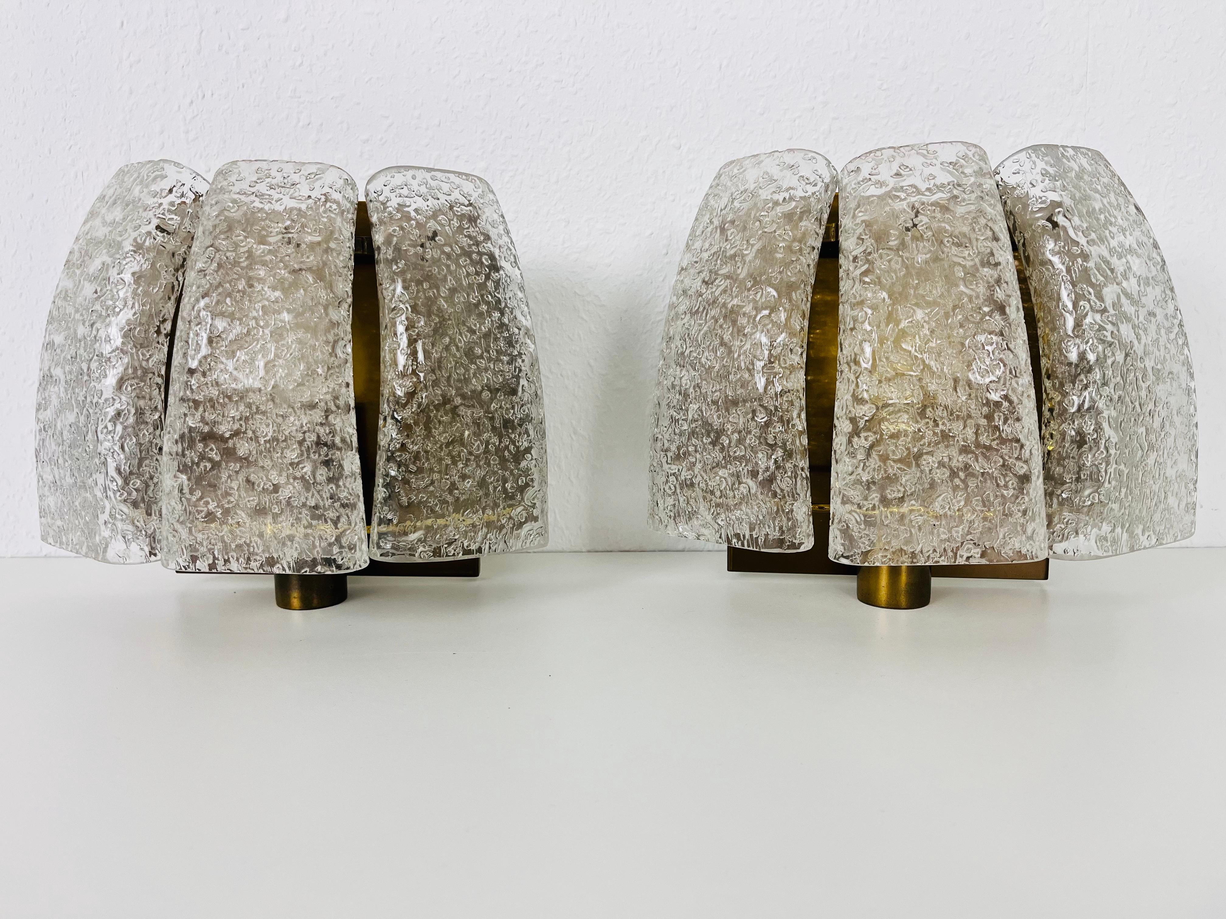 Midcentury pair of beautiful wall lights by the German manufacturer Doria made in the 1960s. The unique glass elements are made from Murano glass.

The lightings require E14 light bulbs. Works with both 120/220V. Very good vintage