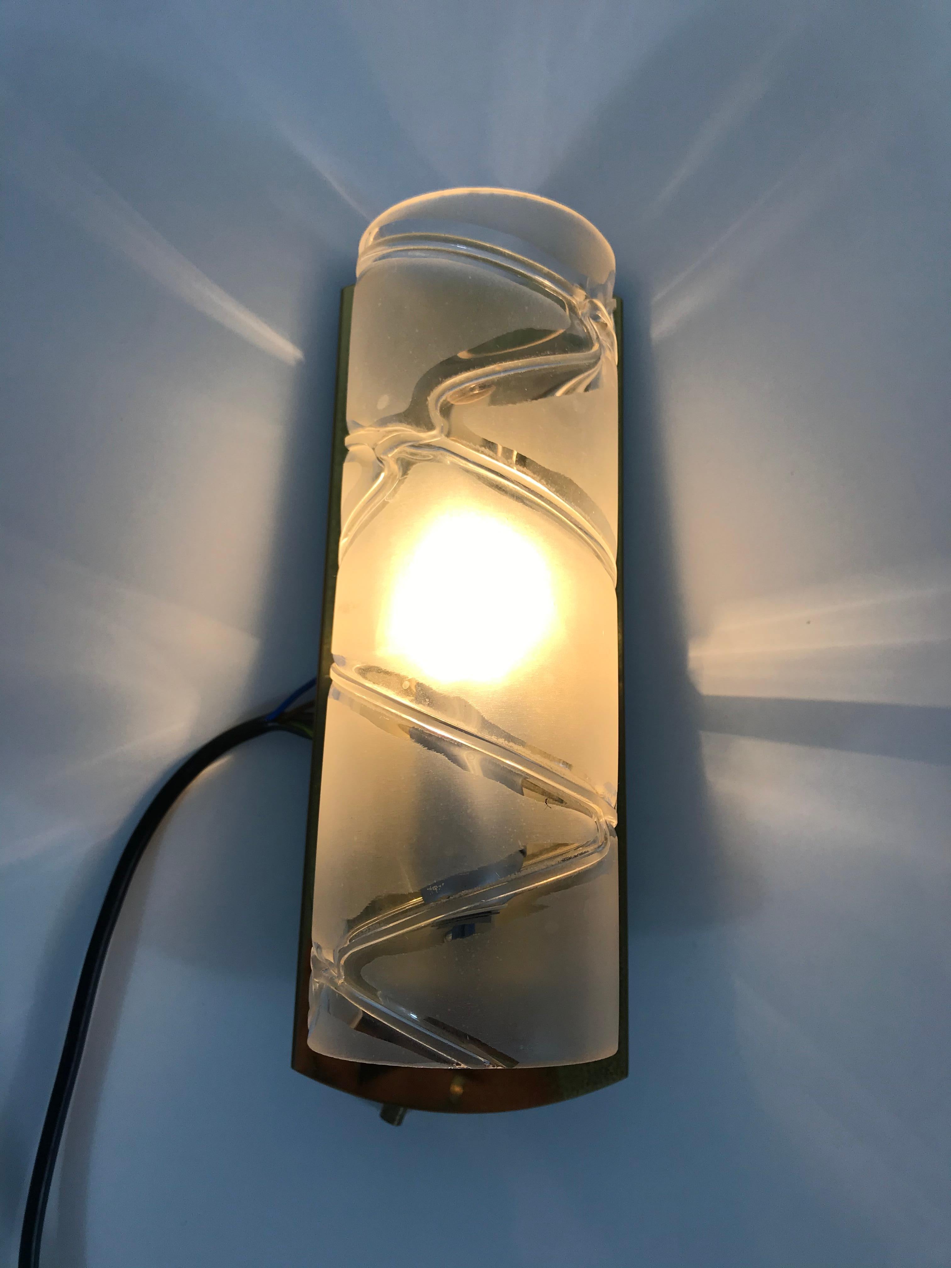 Midcentury pair of beautiful wall lights by the German brand Doria made in the 1960s. They have a beautiful cylinder shape. The unique glass shade is made from glass.