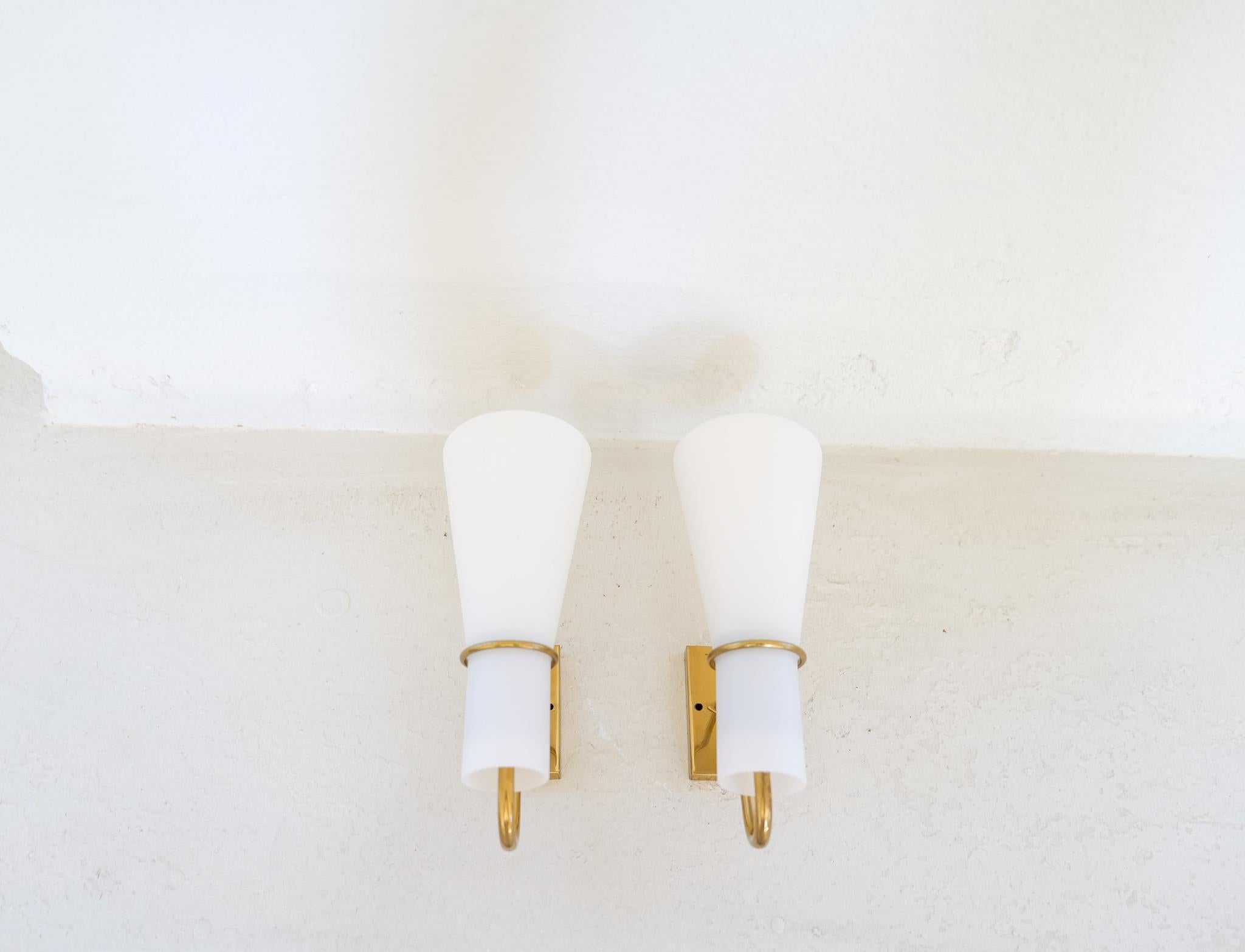 These wall mounted lamps were created in Sweden during the 1950s by Hans Bergström for ASEA Belysning, 

Wonderfully sculptured with brass and matted opaline glass. The matted glass the light gets smooth and cozy. The combination of the golden