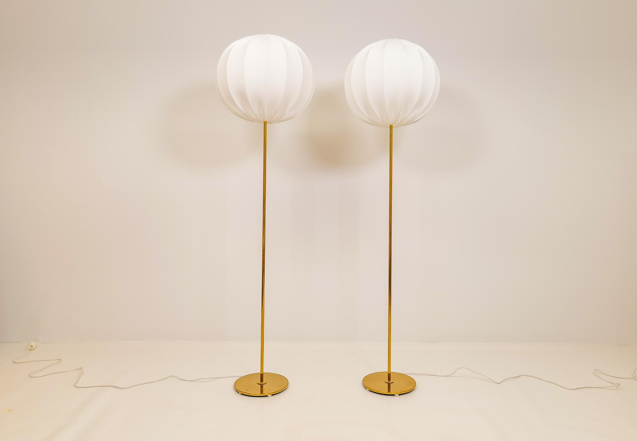 Wonderfully designed floor lamps from Bergboms Sweden. Made in brass and cast iron. They were made in the 1960 with strict rounded lines in brass. These ones come with brand new Swedish cloud shades in cotton, identic to the original ones. 

Good