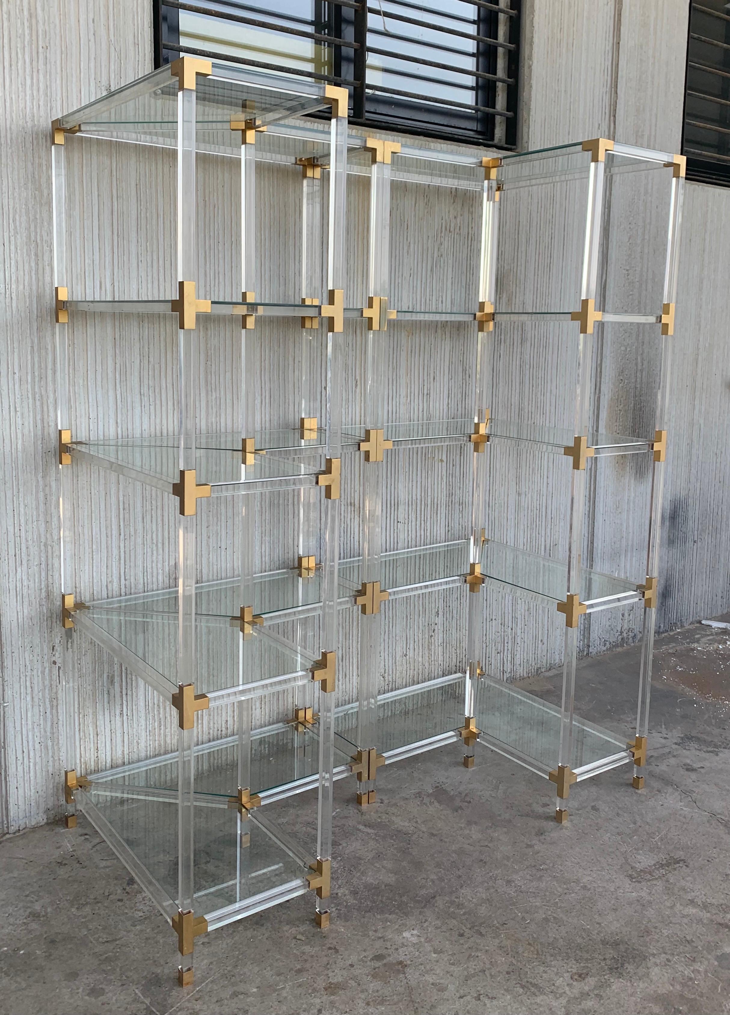 Midcentury pair of brass Lucite and glass corner étagères.
Five shelves
We have three corner étagères available and one more little. One of the matching étagères has an acrylic doors in the low part, you can see in the pictures.

Measures: Deep