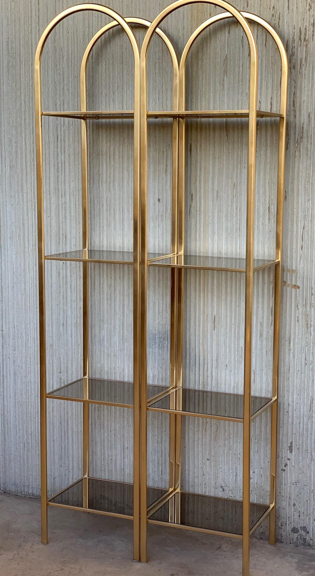 Midcentury pair of brass shelves o étagères with smoked glass
You can remove one metal joint and it disassembled in two shelves.

The piece has a mark on one shelve but is innapreciate.