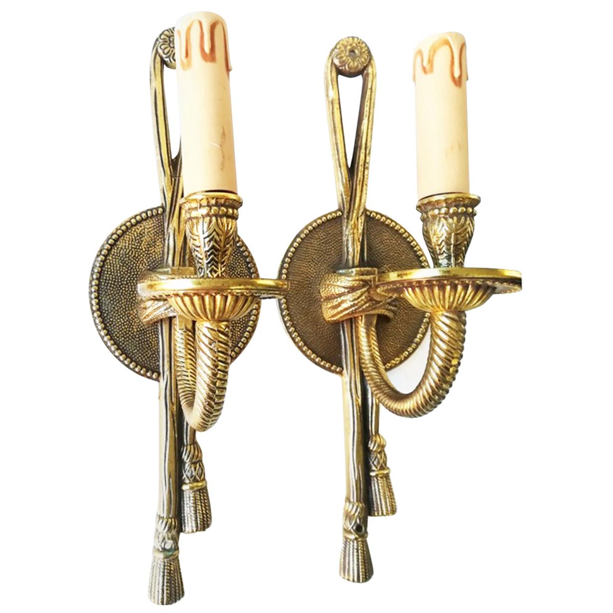 Pair of one arm wall sconces bronze doré or brass, Louis XVI style of the first half of the 20th century.

This model of French wall lamps or sconces have illuminated the Grand Hotels and Cafes with French-style decoration in Europe and around the