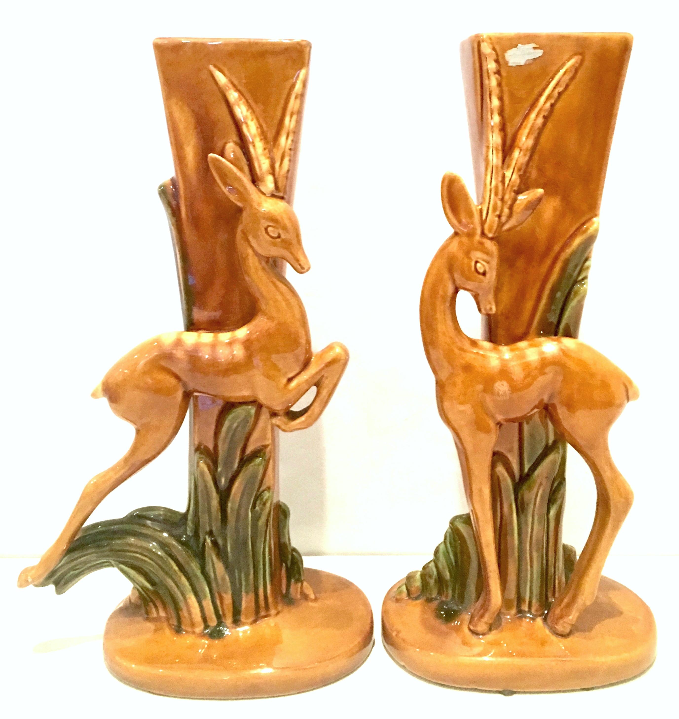 Mid-20th century pair of Art Deco ceramic glaze Gazelle vases by Royal Haeger. This handcrafted, hand painted vase pair features a figural and sculptural fawn in grass motif. This rare found pair are not identical and have small detail variance, per