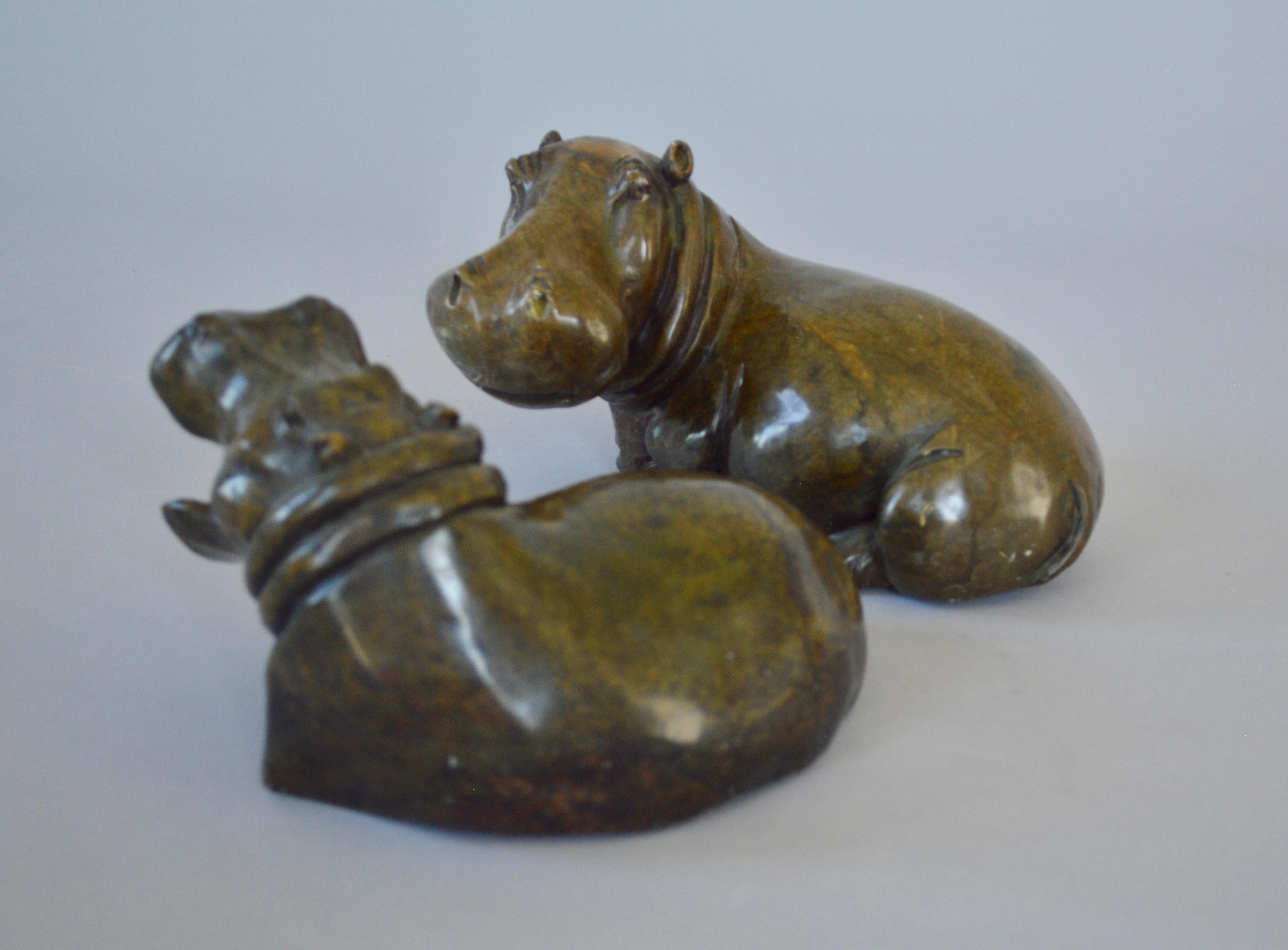Midcentury pair of green hippopotamus sculptures, one of them with open mouth. Carved in green soapstone.