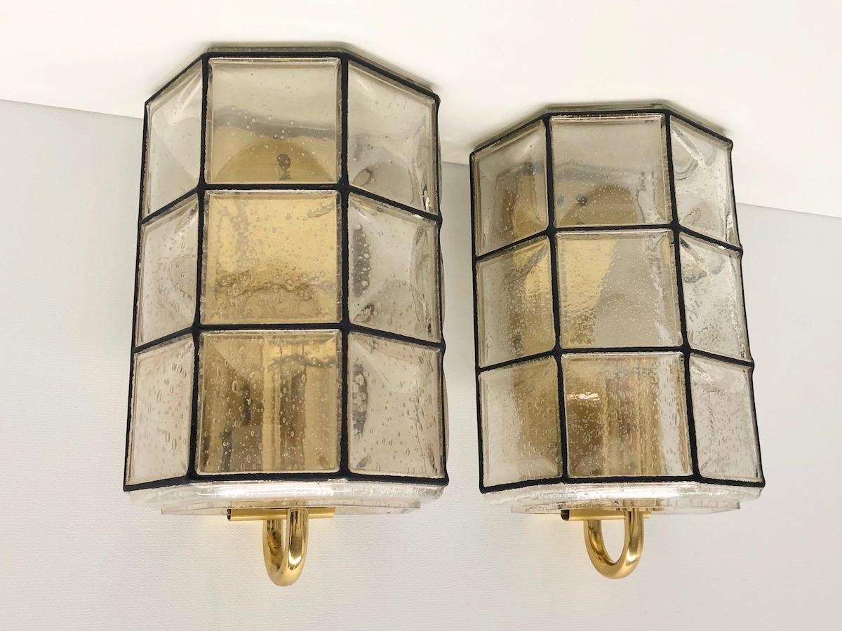 A beautifully pair of geometric, minimal and simply shaped wall lights or sconces by Glashütte Limburg, Germany, made in the 1960s. These midcentury vintage lights feature handmade, mouth blown bubble glass which bulges slightly out of it's black
