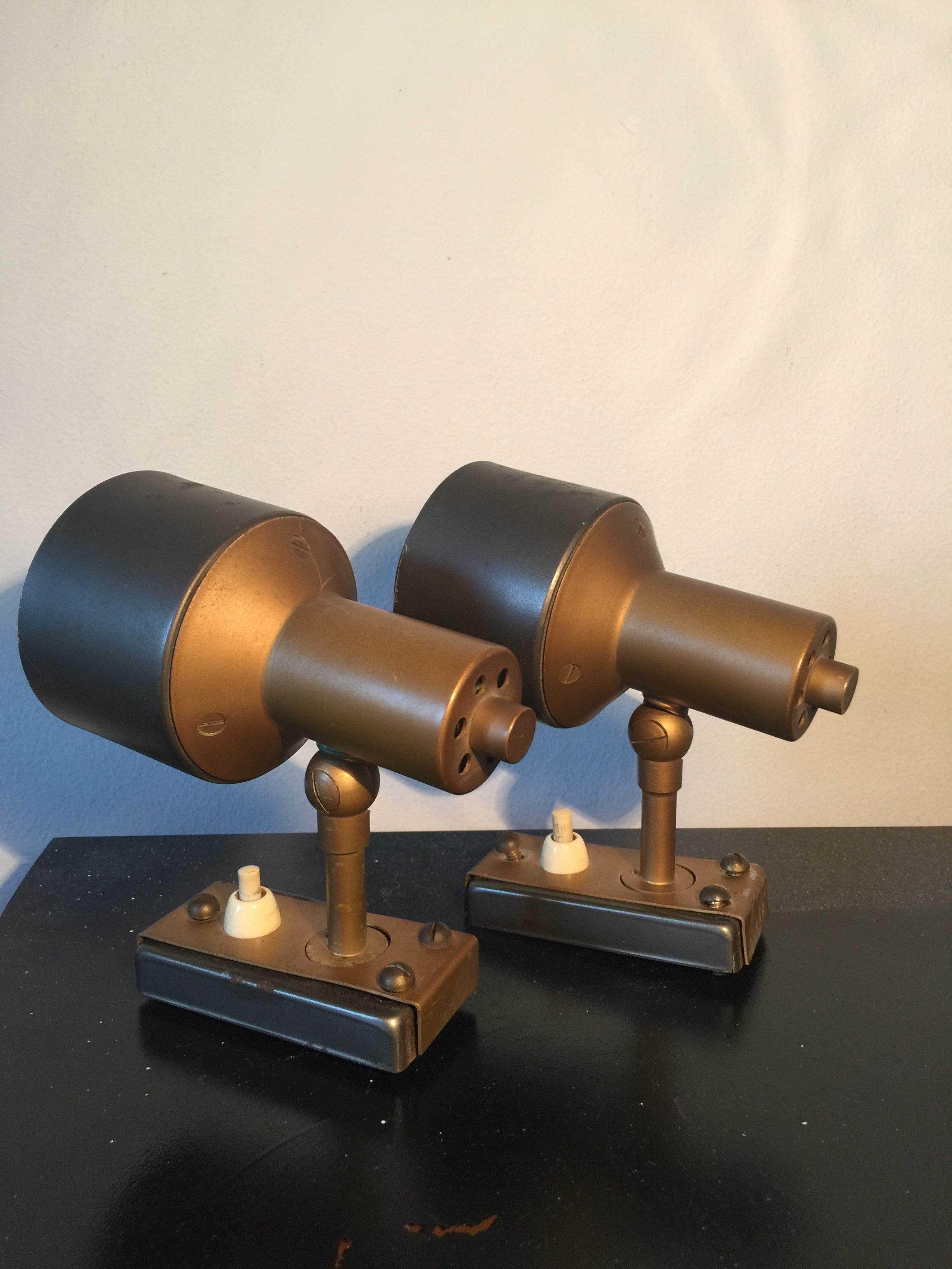 This pair of spotlights was produced in the 1950s in Italy by Stilnovo. They are made from aluminum and brass and are in original vintage condition with some visible scratches.